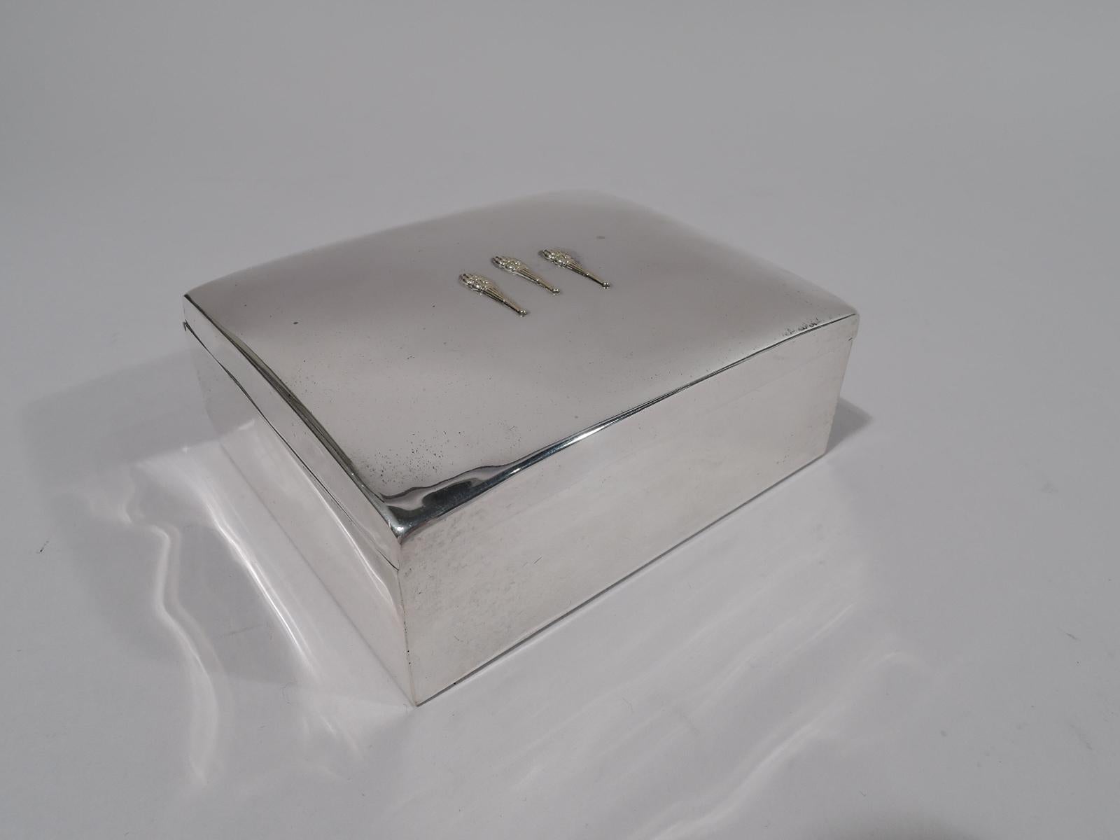 Mid-century Modern sterling silver box. Retailed by Shreve, Crump & Low in Boston. Rectangular with straight sides and sharp corners. Cover hinged and gently curved, and applied with three gilt torches. Box and cover interior cedar lined. Fully