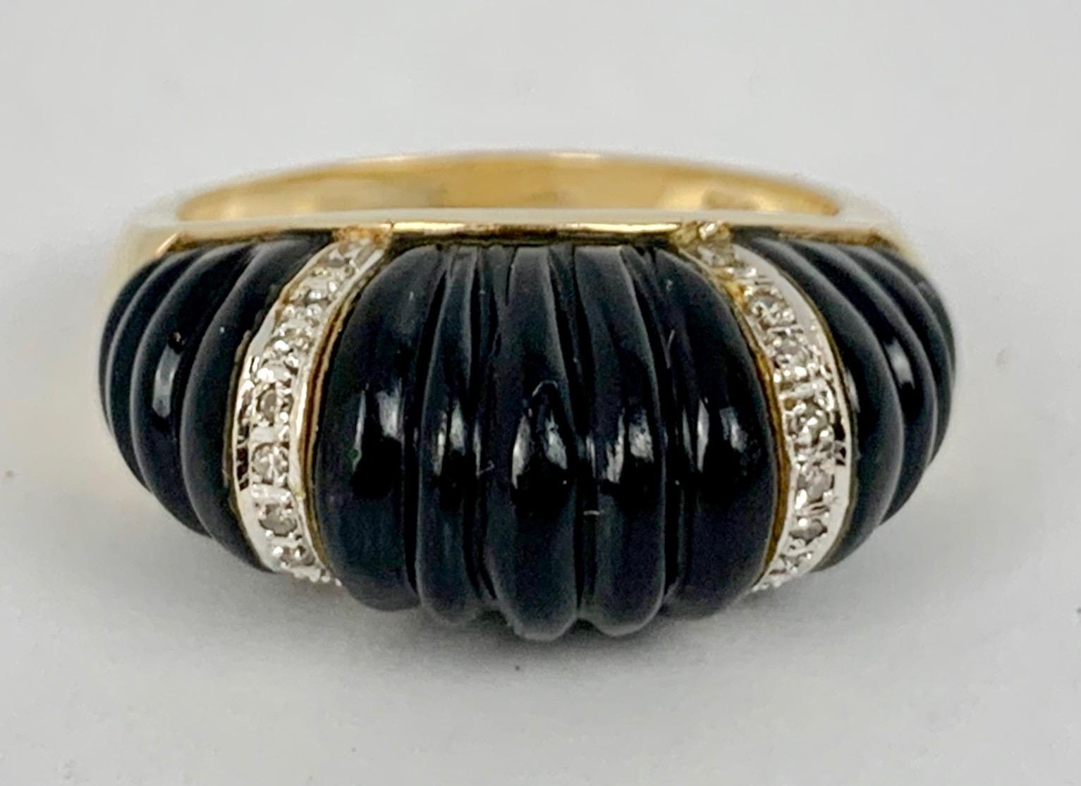 Ladies 14k yellow gold shrimp style ring in carved onyx with two bands of 18 tiny diamonds set in white gold.  Marked on the inside .585 and 14k.  Wonderful looking on a ring finger or perhaps as a pinky ring.
size 8.25 
(This ring can be