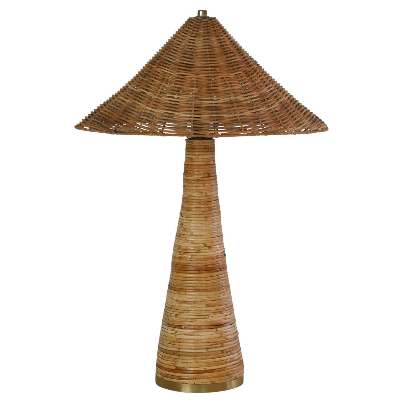 This Shroom Table Lamp - a handcrafted masterpiece inspired by the elegant shape of a mushroom. Made with intricately woven cane and wicker. Its unique design adds a touch of artistry to any room, while its high-quality construction ensures lasting
