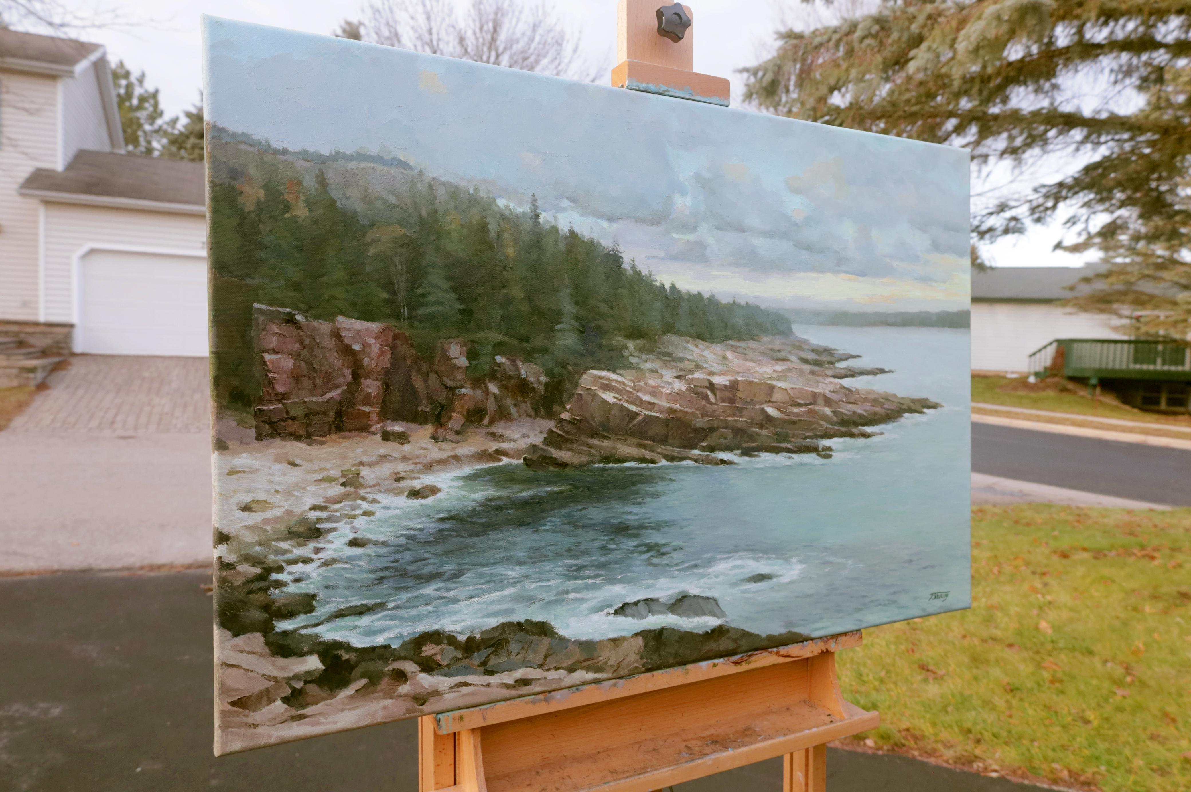 <p>Artist Comments<br>Calm waters meet the rocky shore in this view of the Great Lakes. A soft orange glow peeks behind the clouds, giving faint illumination to the scene. The detailed portrayal of the natural elements lends a realistic touch to the