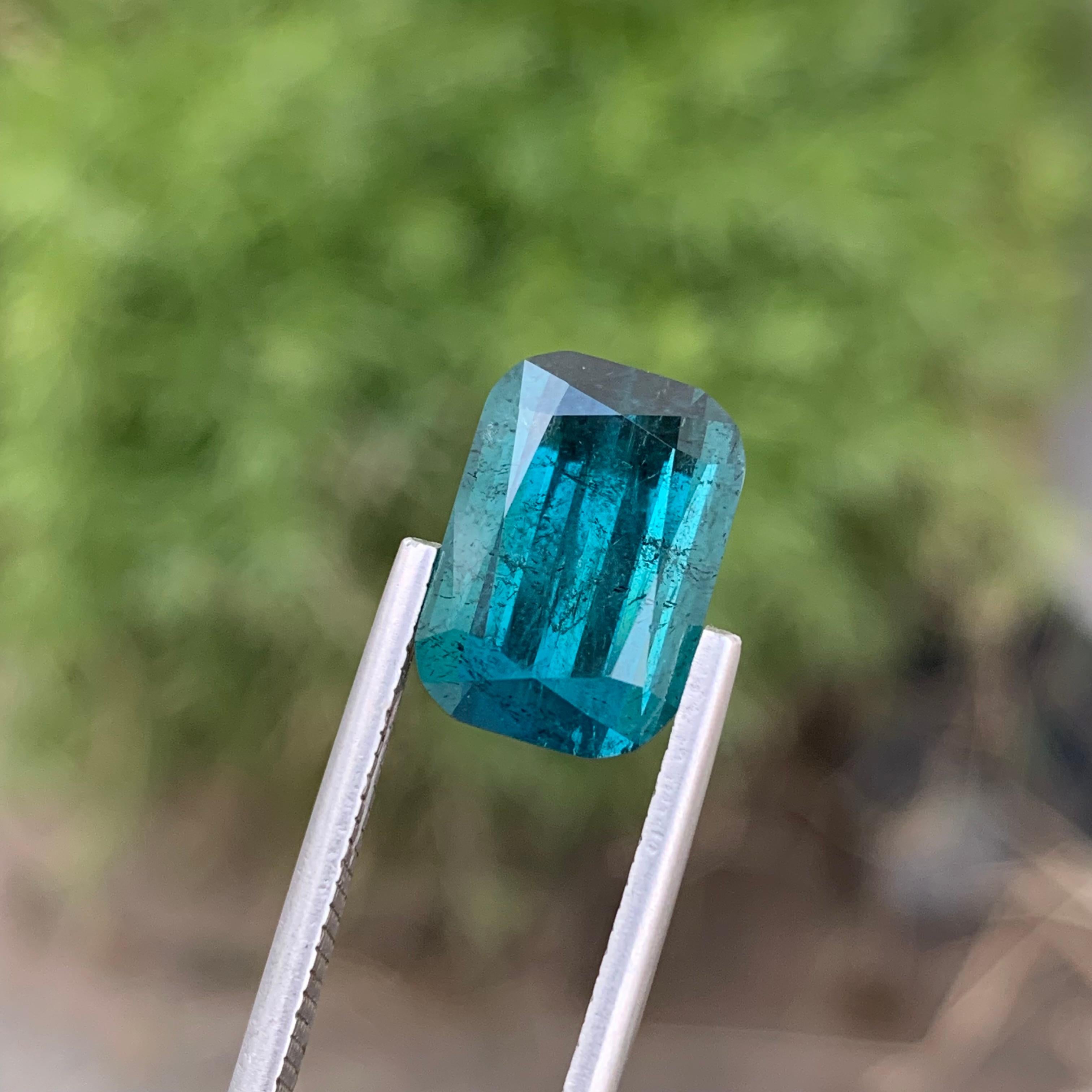 Loose Indicolite Tourmaline 
Weight: 7.90 Carats 
Dimension: 12.9x9x7.6 Mm
Origin: Kunar Afghanistan 
Shape: Cushion
Color: Deep Blue
Treatment: Non
Clarity: Small Included
Certificate: On Demand 
Indicolite tourmaline, a captivating variety of