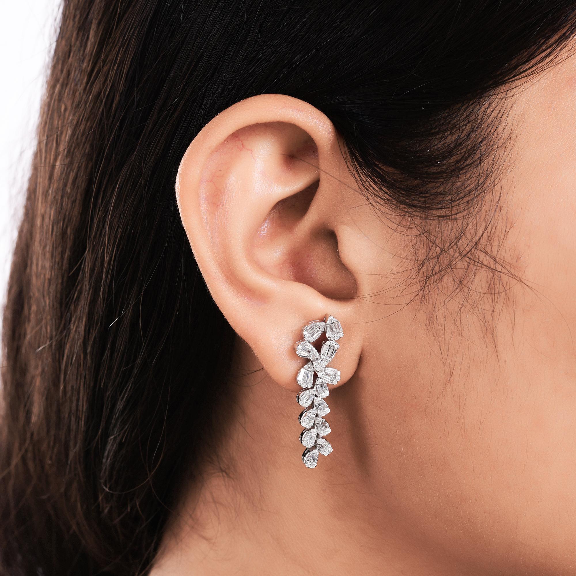 Each earring features a stunning array of baguette-cut diamonds, renowned for their sleek and elongated silhouette. These diamonds showcase SI clarity and HI color, ensuring a mesmerizing brilliance that catches the light with every movement. The