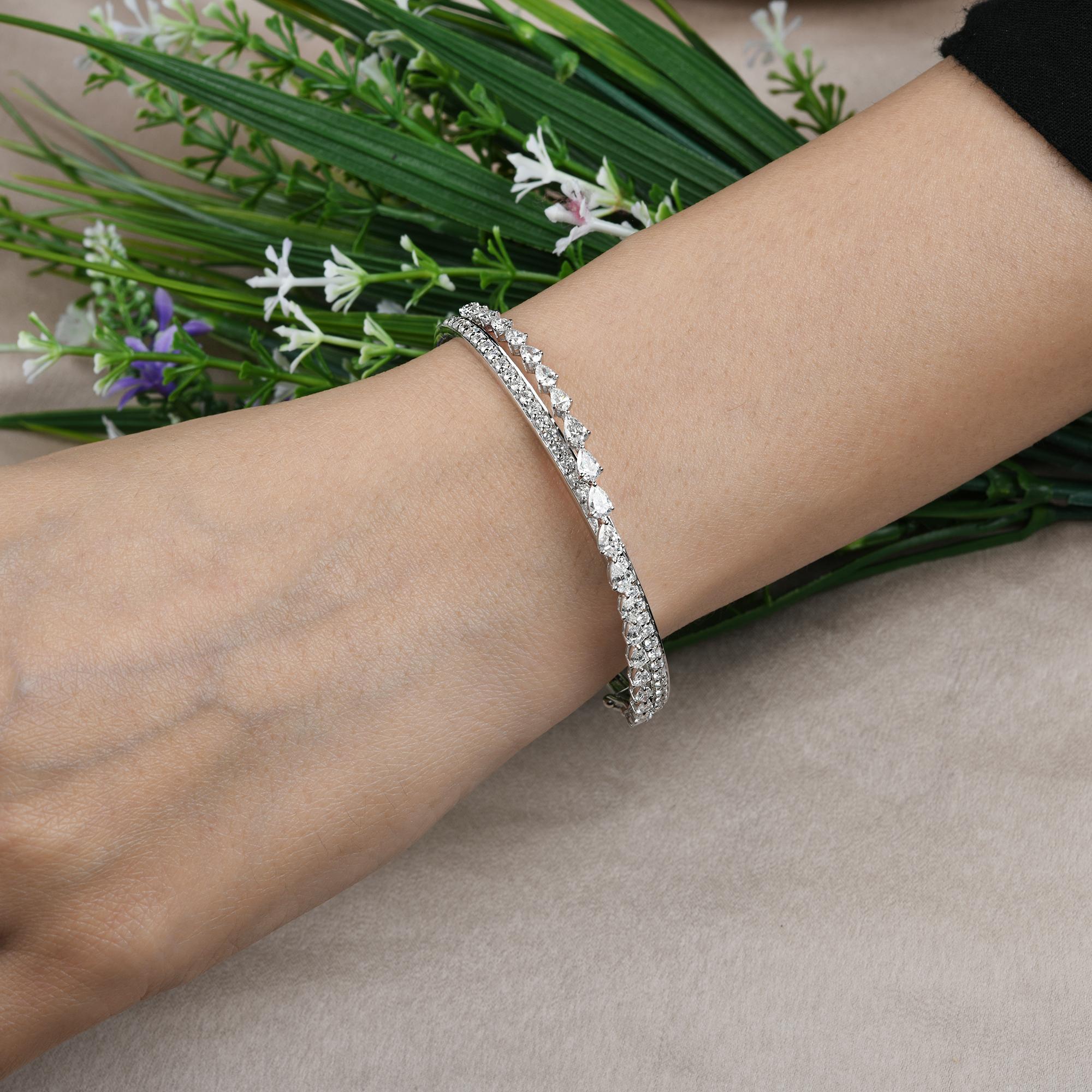 SI Clarity HI Color Pear Round Diamond Cuff Bangle Bracelet 18 Karat White Gold 
The bracelet features a dual-row diamond layout. One row showcases a delicate arrangement of pear-shaped diamonds, the second row highlights perfectly matched round