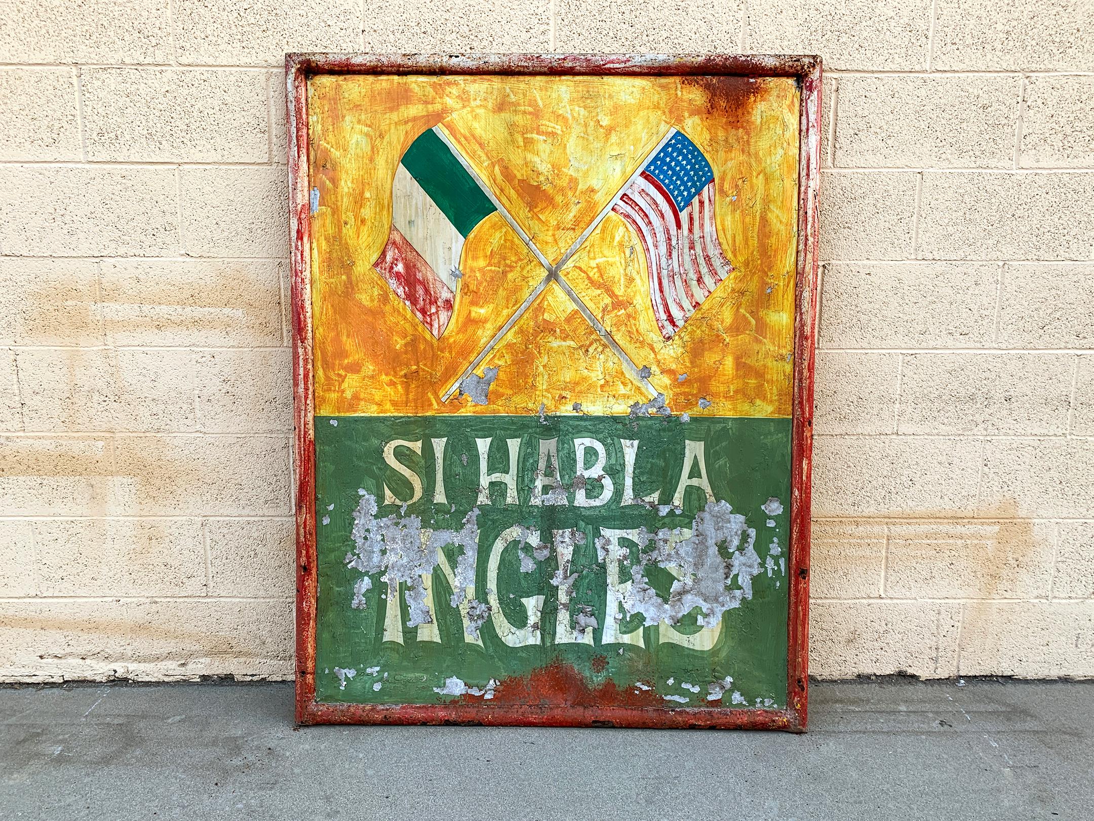 Si Habla Ingles. This hand painted, double sided sign comes from an old Mexican Cantina in New Mexico. It's a unique gem with tons of character. Paint on metal in original frame. It's old, probably dating back to the 1960s or 1970s. One side has