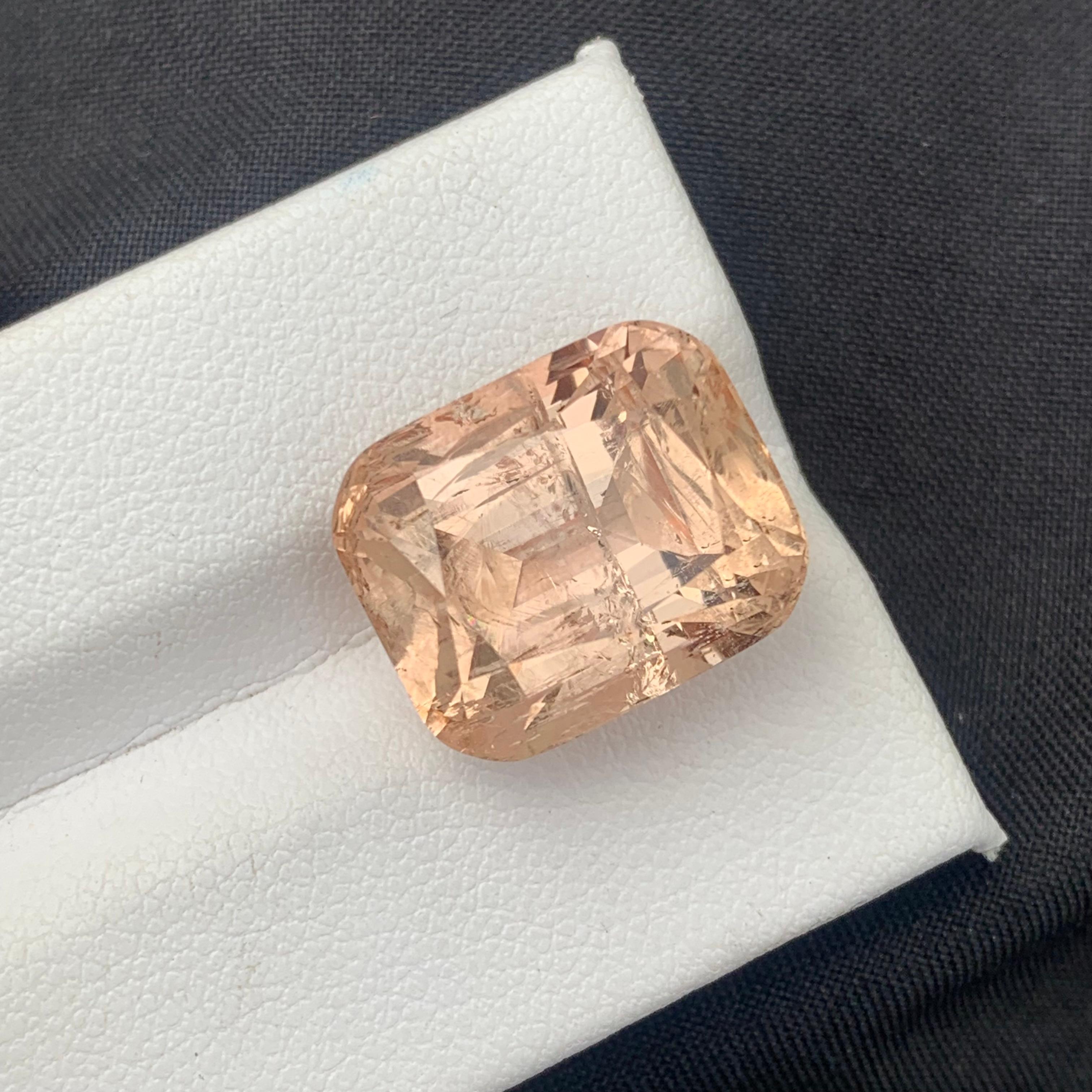 Faceted Imperial Topaz 
Weight: 20.30 Carats
Dimension: 15.5x12.8x11.1 Mm
Origin: Katlang Pakistan 
Shape: Cushion
Color; Peach Imperial 
Clarity: Included
Treatment: Non
Certificate: On Demand 
Imperial Topaz encourages healthy boundaries and helps