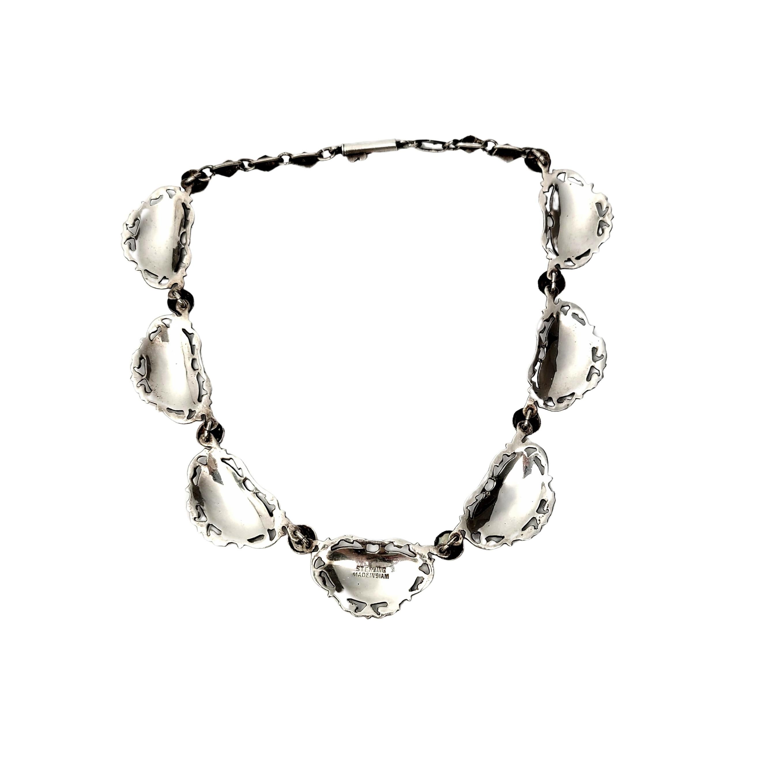 Siam sterling silver and niello enamel choker necklace.

Beautifully ornate black niello enamel with etched Hindi goddess dancer links alternate with round silver and niello connectors. Open scroll work frames each goddess link. Diamond shaped