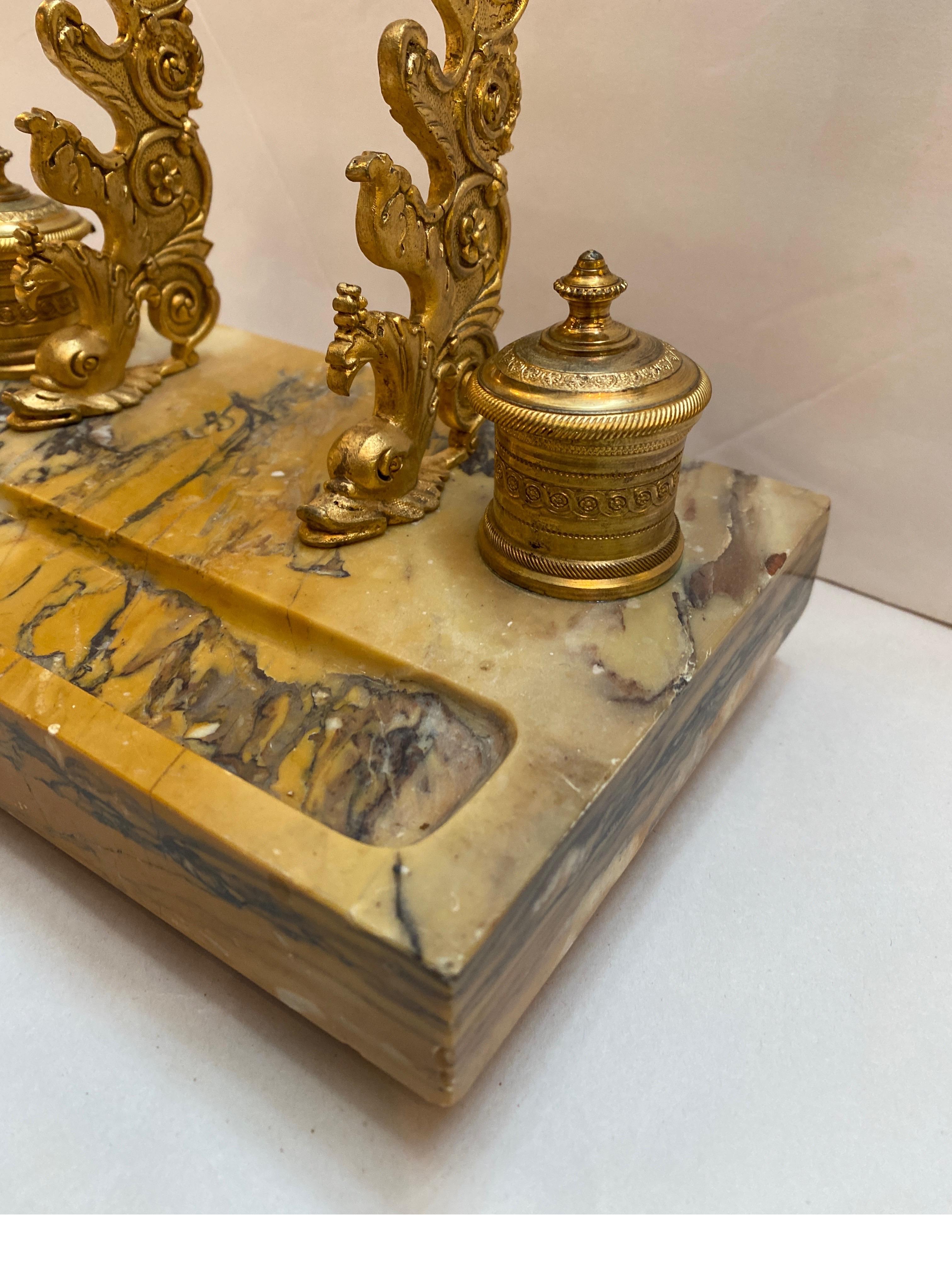 Elegant antique Siena marble and gilt bronze inkstand inkwell. The hand carved marble base with gilt bronze pen holder with two gilt bronze inkwells with original gilt decoration. Smaller size at 9.52 wide, 8 high, 5.25 deep, and elegant desk