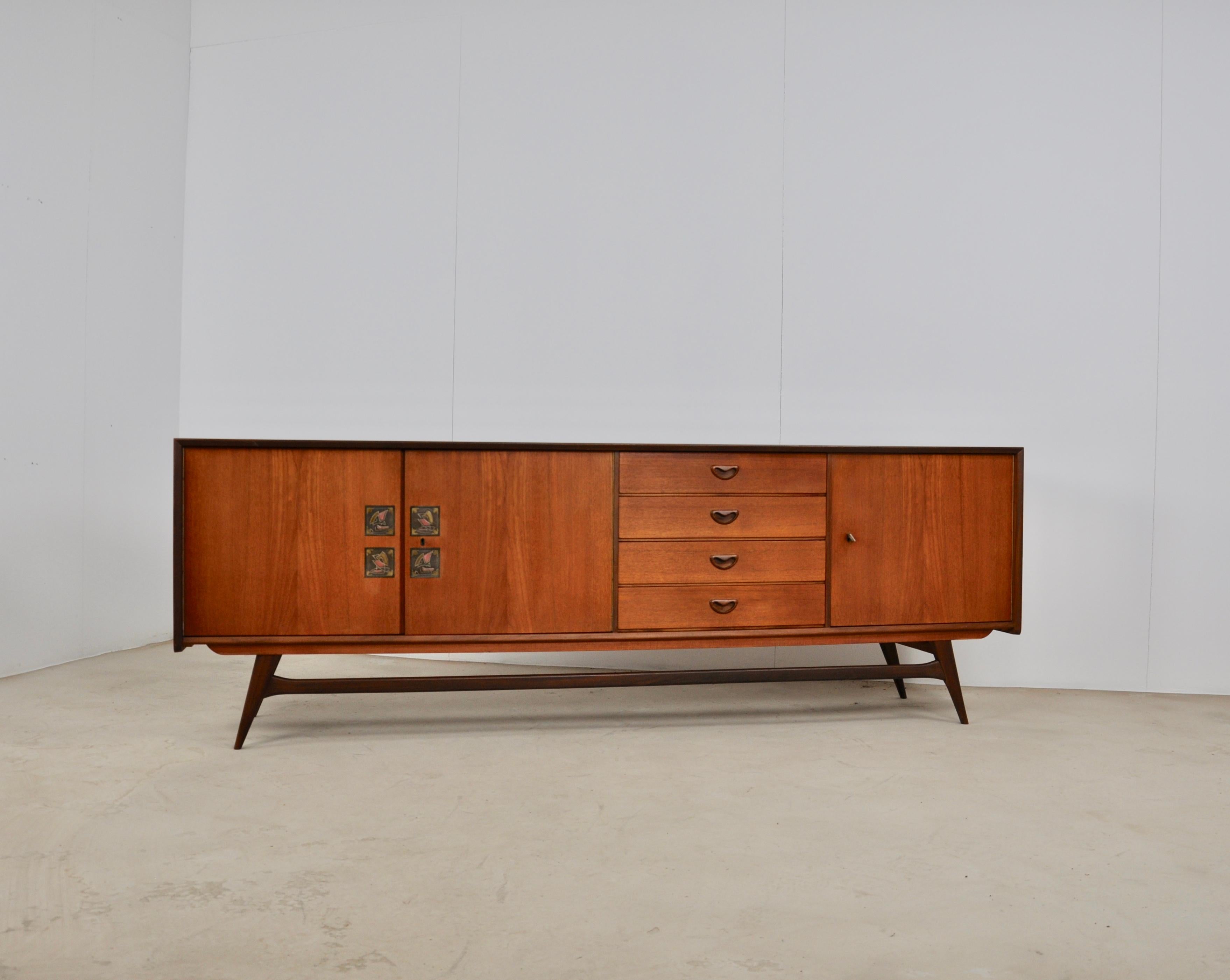 Sideboard with 3 doors and 4 drawers. Very light wear and tear due to time and use.