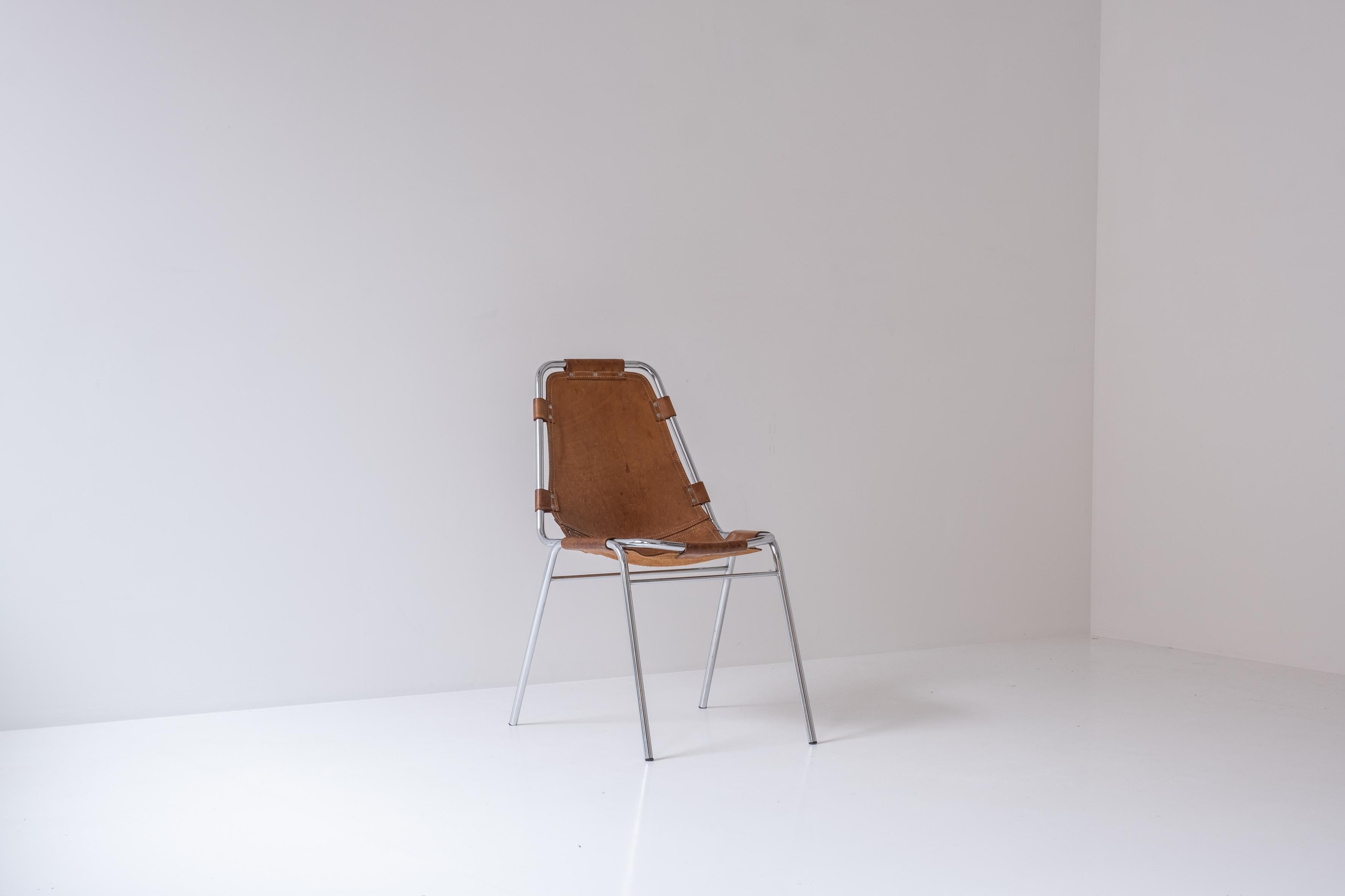 Side chair selected by Charlotte Perriand for Les Arcs, France 1970s. This chair features a tubular steel frame and cognac leather seat. Well presented condition, with a soft overall patina.