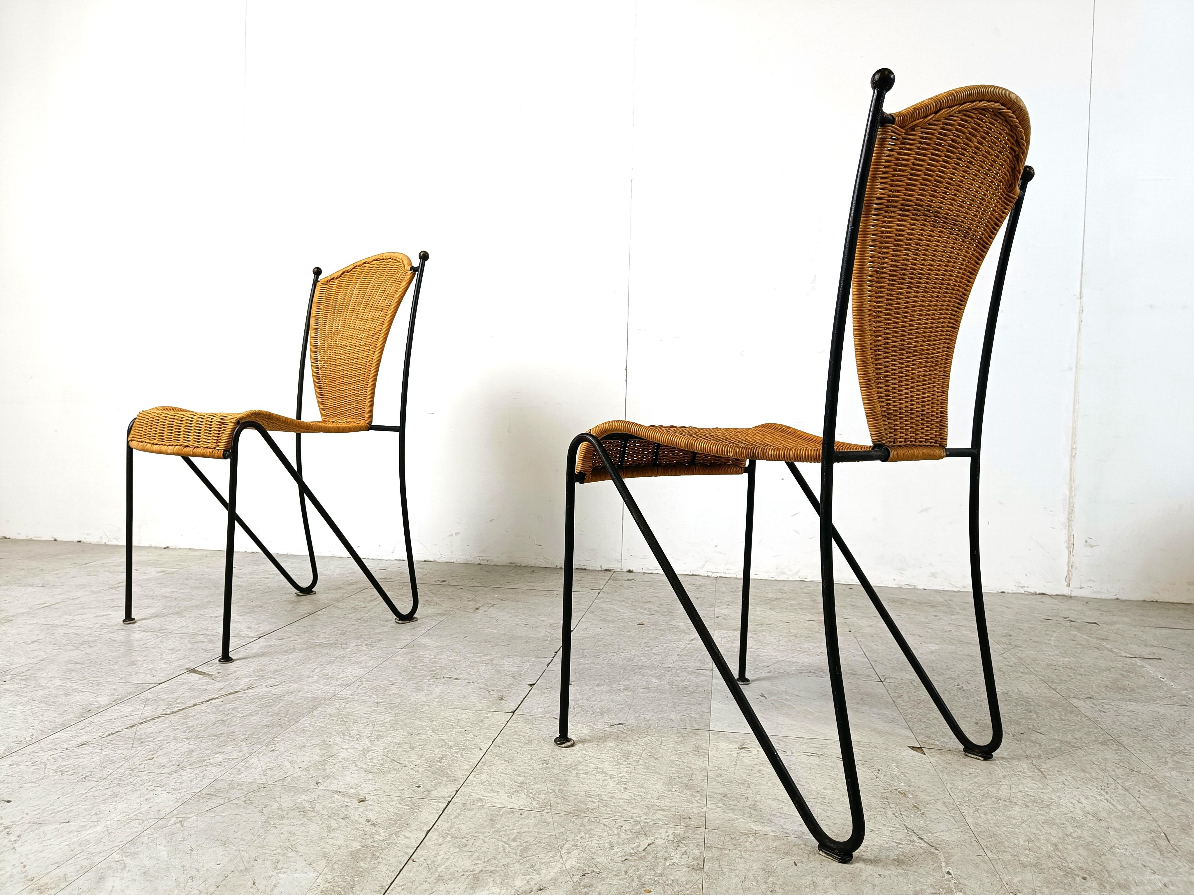 Vintage wrought iron and wicker bistro/dining chairs designed by Frederick Weinberg.

Elegant black wrought frame with a curvy wicker seat.

Very sturdy chairs good for in home and outside use.

1960s - France

Very good