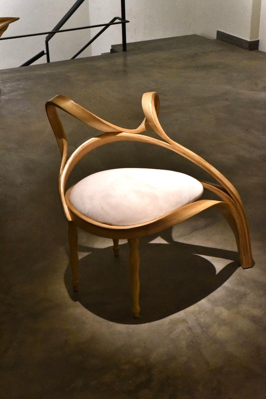 The Chair No. 5 of the Vrksa Series is a filler chair that is crafted in either Ash wood or Oak, using wood bending techniques. One of the legs of the piece emerges from the frame of the chair and the other three legs are crafted using woodturning
