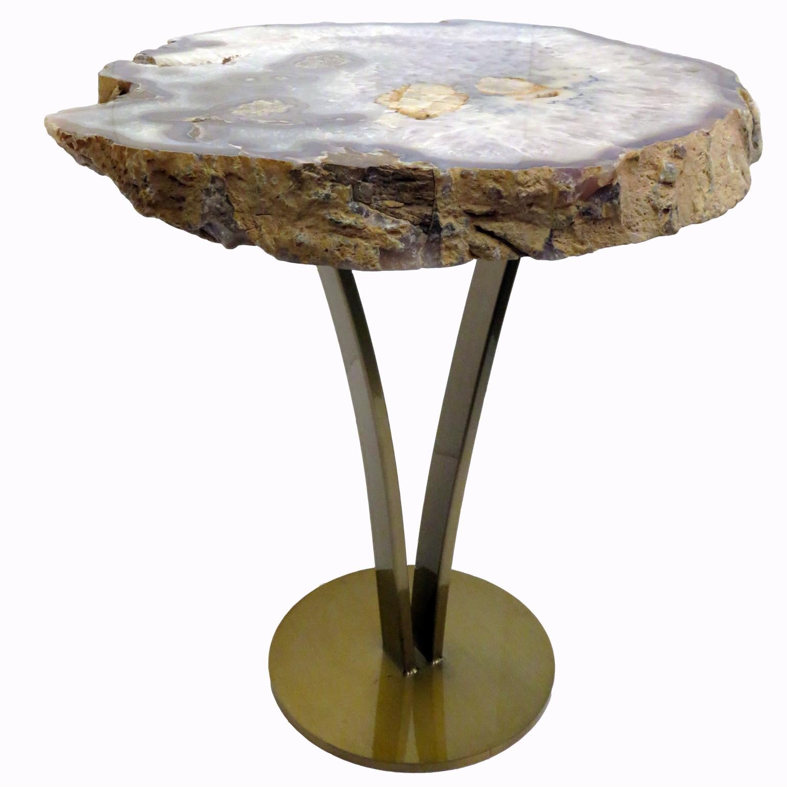 This agate slab forming a side table or cocktail table, is from Brazil and has a combination of colors with hints of blue, grey and white. Agates are formed in rounded nodules, which are sliced open to bring out the internal pattern hidden in the