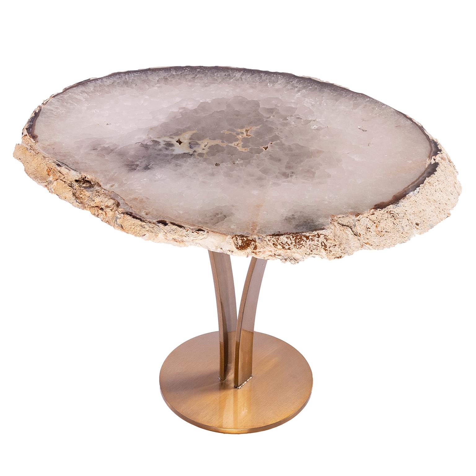 This agate slab forming a side table or cocktail table, is from Brazil and has a combination of colors with hints of blue, grey and white. Agates are formed in rounded nodules, which are sliced open to bring out the internal pattern hidden in the