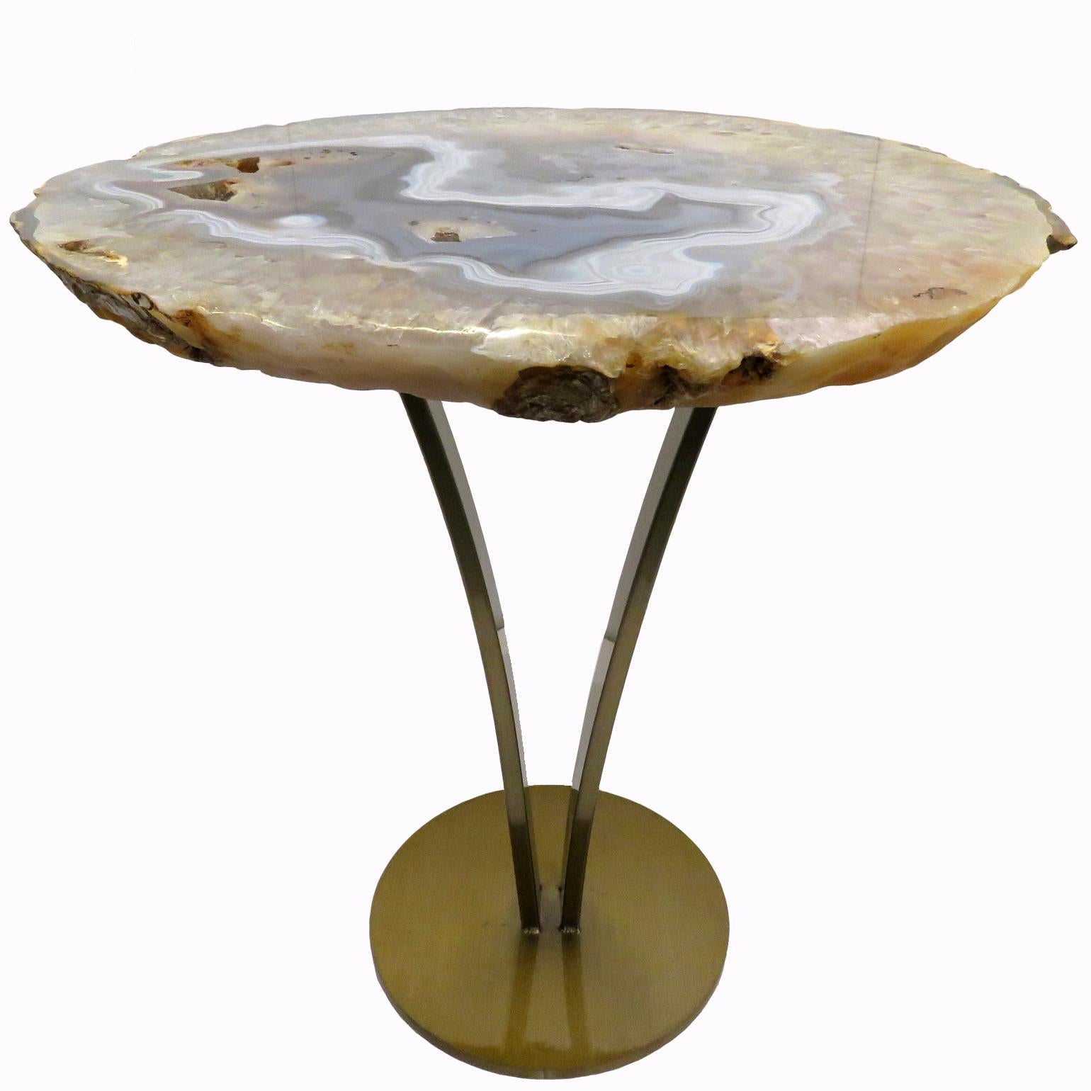 This agate slab forming a side table or cocktail table, is from Brazil and has a combination of colors with hints of beige, blue and brown. Agates are formed in rounded nodules, which are sliced open to bring out the internal pattern hidden in the