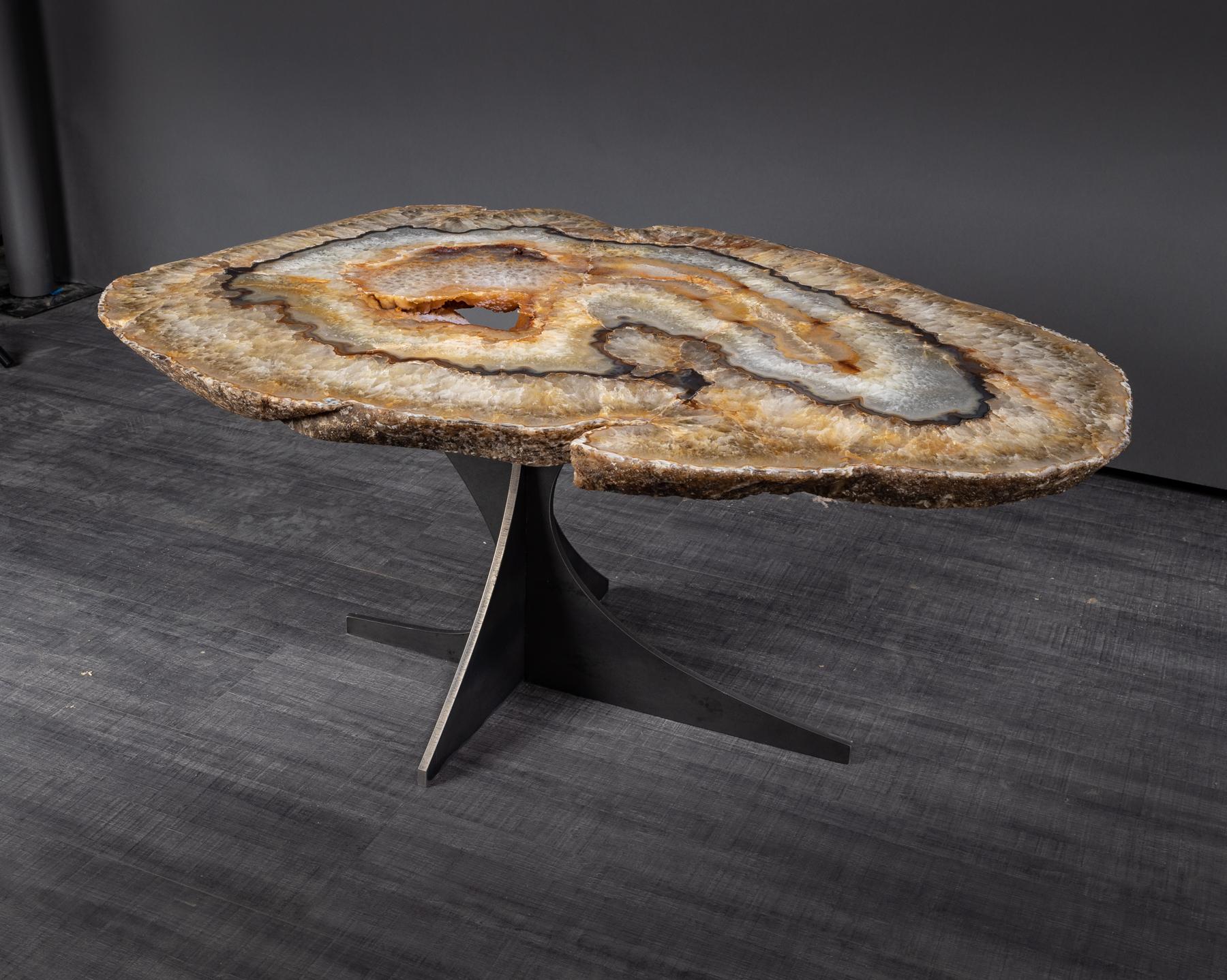 This agate side table or cocktail table is from Brazil and has a combination of colors with hints of beige, brown and white. Agates are formed in rounded nodules, which are sliced open to bring out the internal pattern hidden in the stone. Their