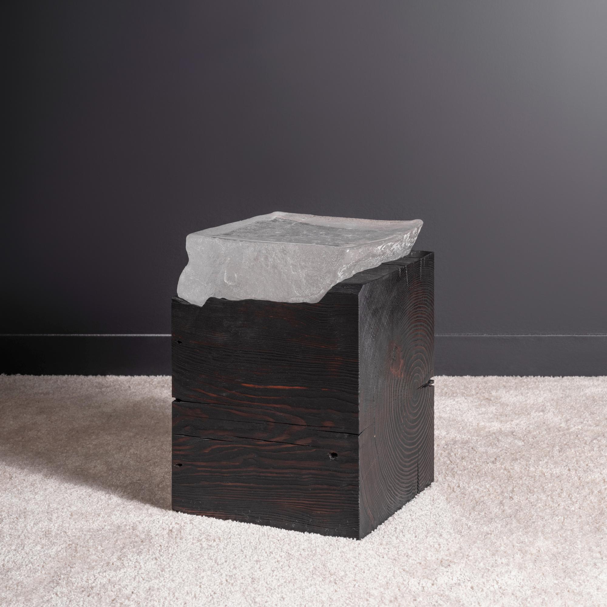 One-of-a-kind side or end table in hand-carved and charred reclaimed wood with cast glass top. Fueled by curiosity while pushing function and materiality to its limits, this piece would make an evocative yet understated sculptural accent to your