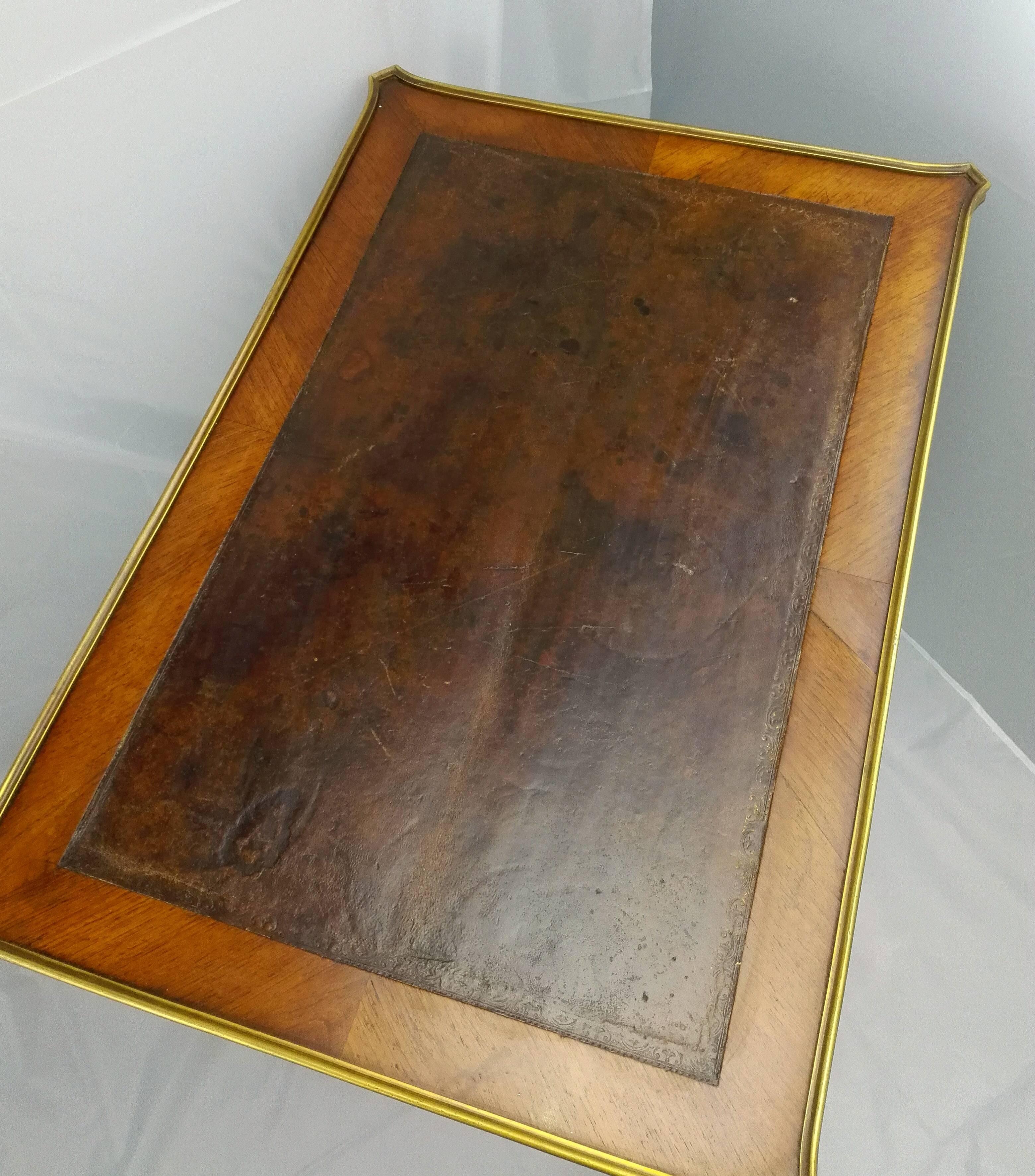 This special and very rare work or side table in black - red-brown shining amaranth, with fire gilded feed shoes and keyhole fitting, so like the brass mounting in the top, it’s typical for the work before Louis XVI! The swinging and very fine