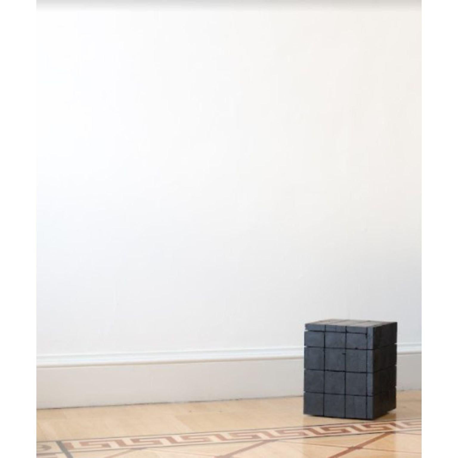Table d'appoint 018 de Jesper Eriksson
Dimensions : D 43,5 x L 47,7 x H 49,2 cm 
MATERIAL : Charbon anthracite, cadre en bois
Poids : 60 kg

Jesper Eriksson (né en 1990 à Paris) est un artiste et un designer basé à Londres, qui s'intéresse au