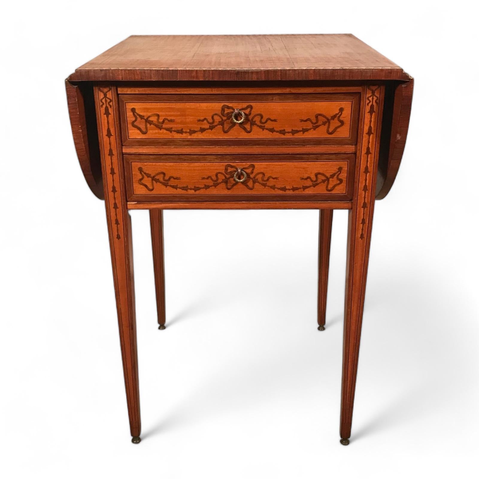Explore a charming vintage find with our Georgian style side table, dating back to the early 20th century. Standing elegantly on slender legs, this table features a convenient flip-up top adorned with a delightful floral wood inlay on its front,