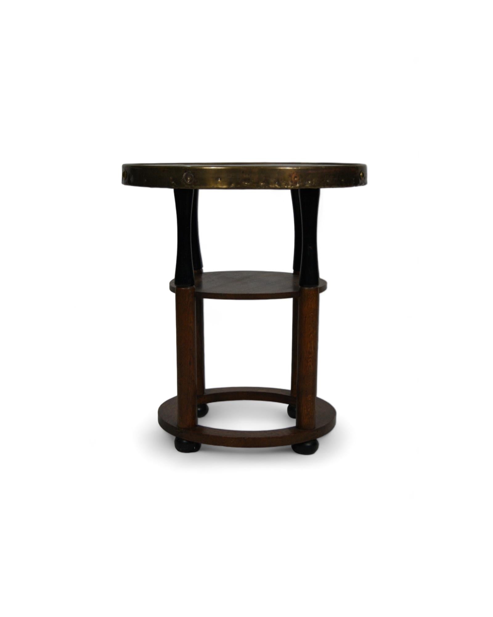 A timeless gem: a vintage Art Nouveau side table, evoking the elegance and charm of the early 20th century. With its meticulously carved hardwood structure, this table breathes the sophistication of a bygone era, where craftsmanship was elevated to