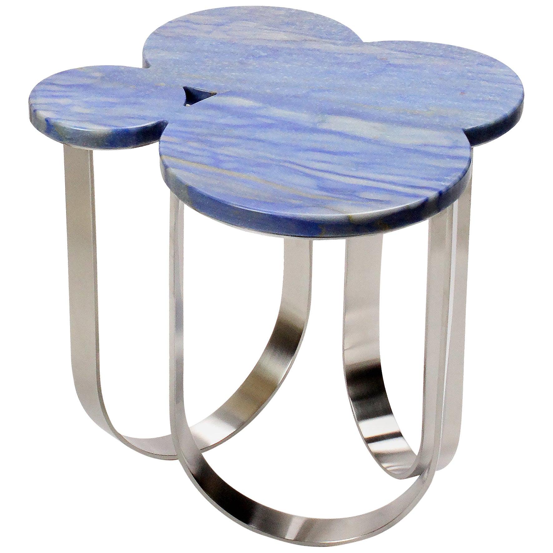 The 'Cloud' is a spectacular side table with structure in mirror polished stainless steel and top in Azul Macaubas quartzite. The mirror-like finishing of the stainless steel creates different perceptions of this particular material and allows