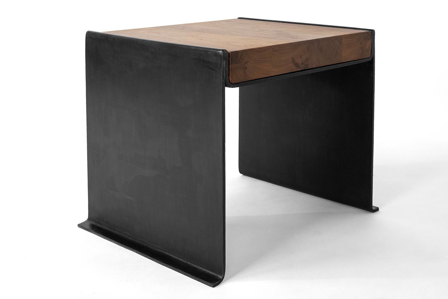 TABLE NO. 19
J.M. Szymanski
d. 2023

With the combined power of our steel smith and the modern machine, this table is hydrology bent from 3/8” thick solid steel. It is hand finished in a rich and warm black patina. A modern classic for generations