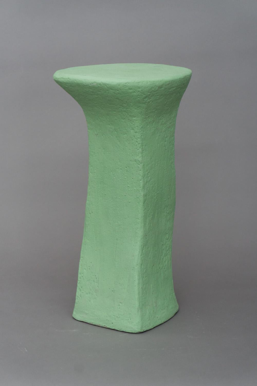 Solid and unique side table made of grey stoneware with a fresh green engobe. Unique and artistic piece by Danish designer and artist Christine Roland. Also used as a seating object due to it's strong production. 
Other models and colors are