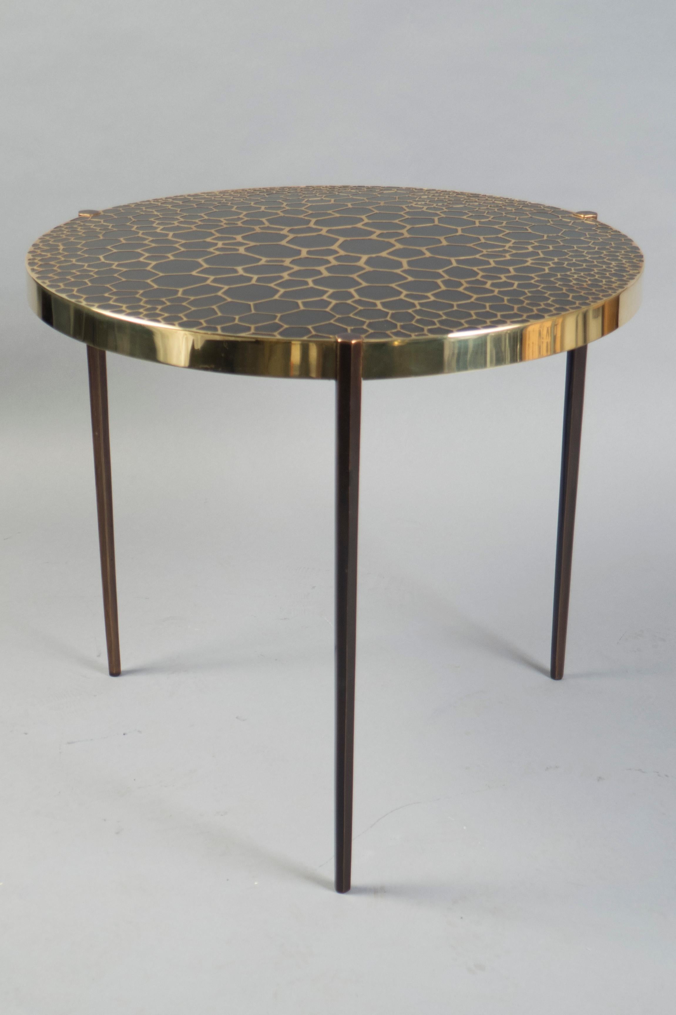Patinated and polished bronze side table, the top featuring a loose cellular motif throughout. 
Plaque under top.
 