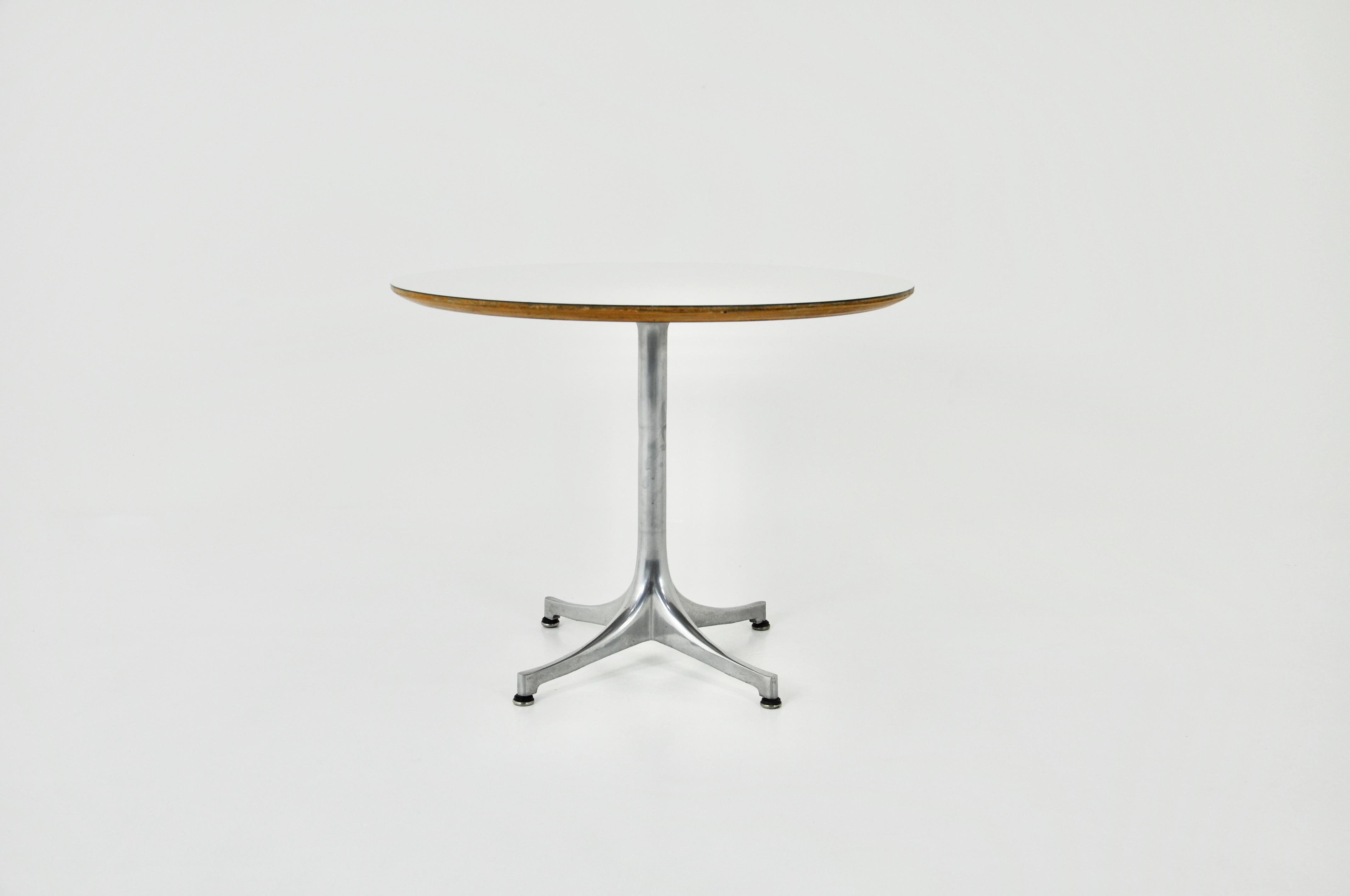 Table with white wooden top and metal base designed by George Nelson and produced by Herman Miller in the 1960s. Wear due to time and age of the table.