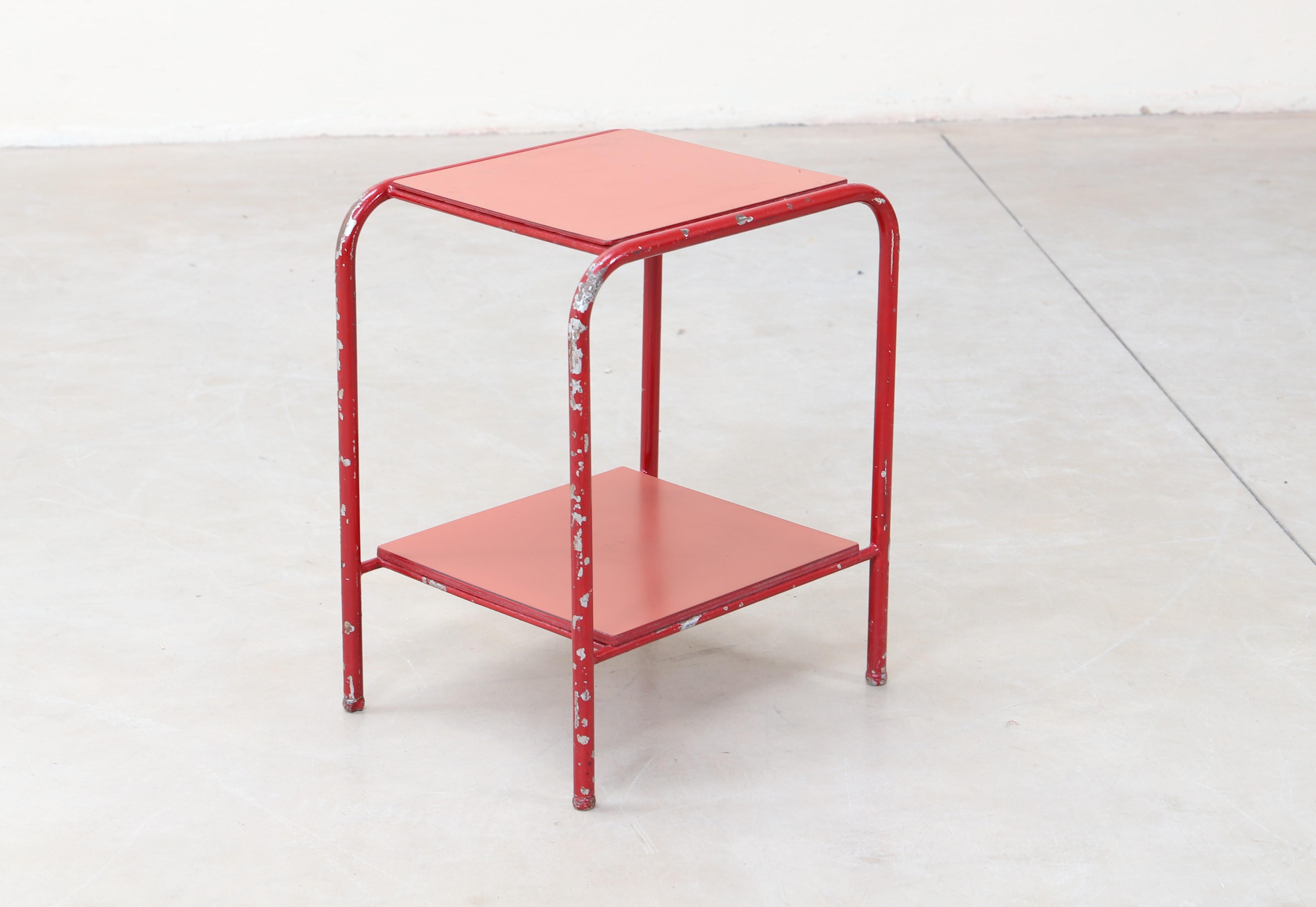 Side table in metal tube entirely lacquered in red-blood color.

Furniture designed in 1934-1935 for the sanatorium of Guébriant and sponsored by the French Army to the architects Abraham and Jacques Henri Le Même. Jules Leleu was the decorator.