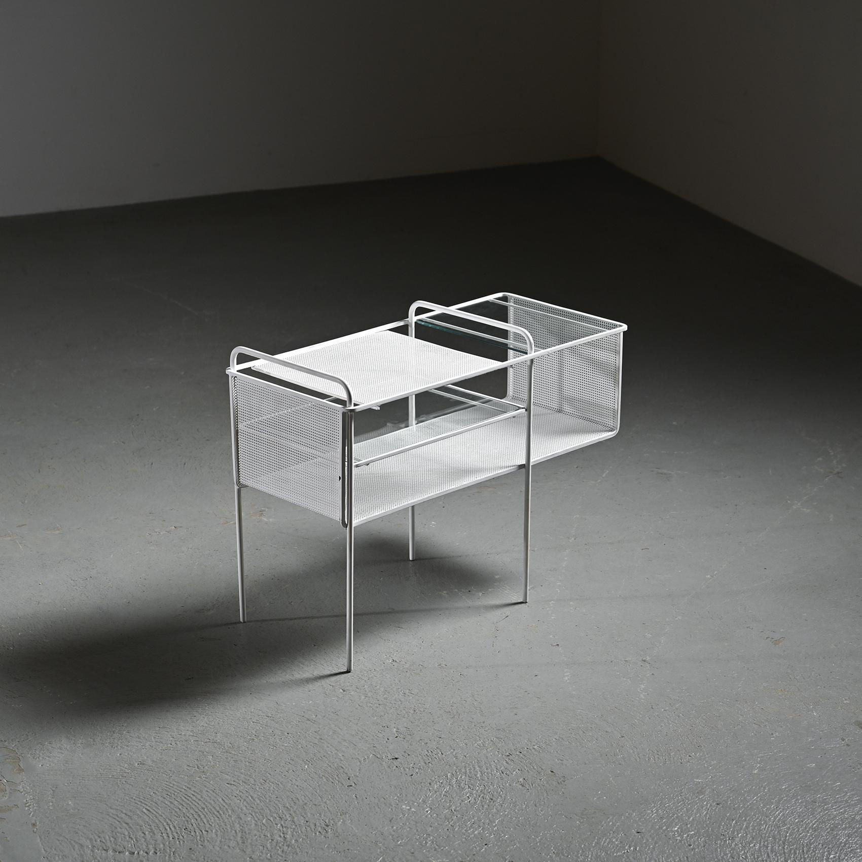 
Side table originally designed as a record holder by French designer Mathieu Matégot, circa 1950.

This distinctive piece stands out for its cylindrical tubular metal structure forming the base, combined with Matégot's signature use of white
