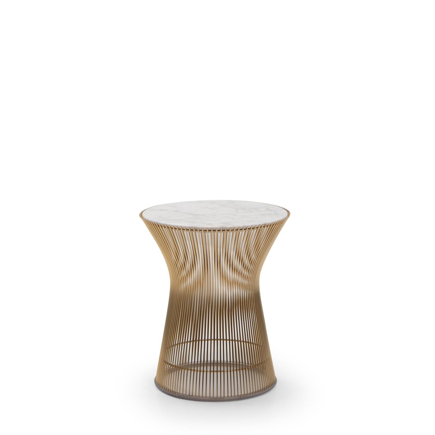 Originally designed by Warren Platner in 1966 for Knoll International, this iconic side table features a sculptural base composed of 18k gold-plated steel rods, carefully curved and welded to a circular frame. 

Though substantial in weight due to