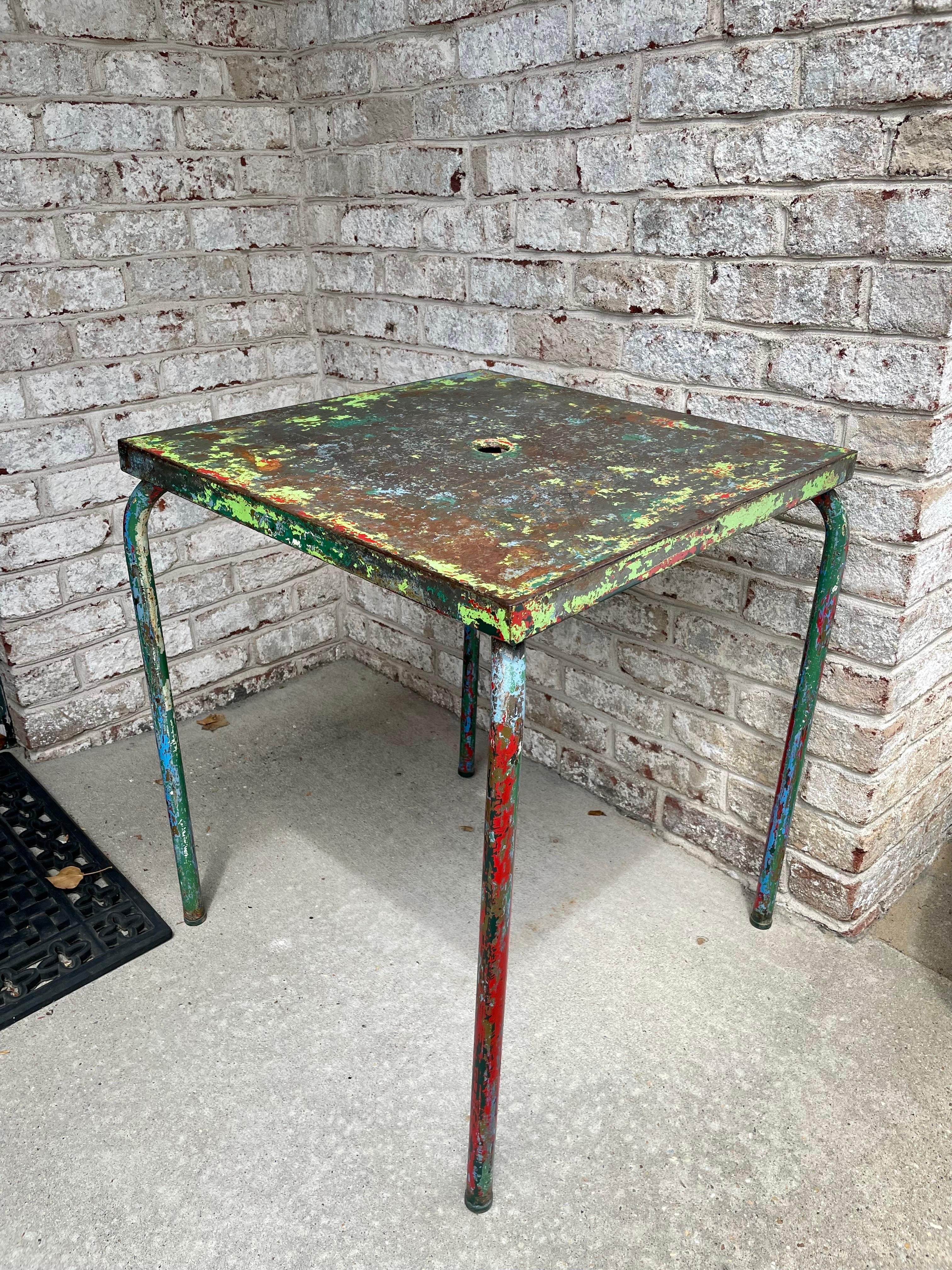 Side table in metal tube entirely covered in a colorful mix of paint and patina acquired over years of use and enjoyment, center hole is original, Truly an art piece. Often attributed to Jean Prouve.