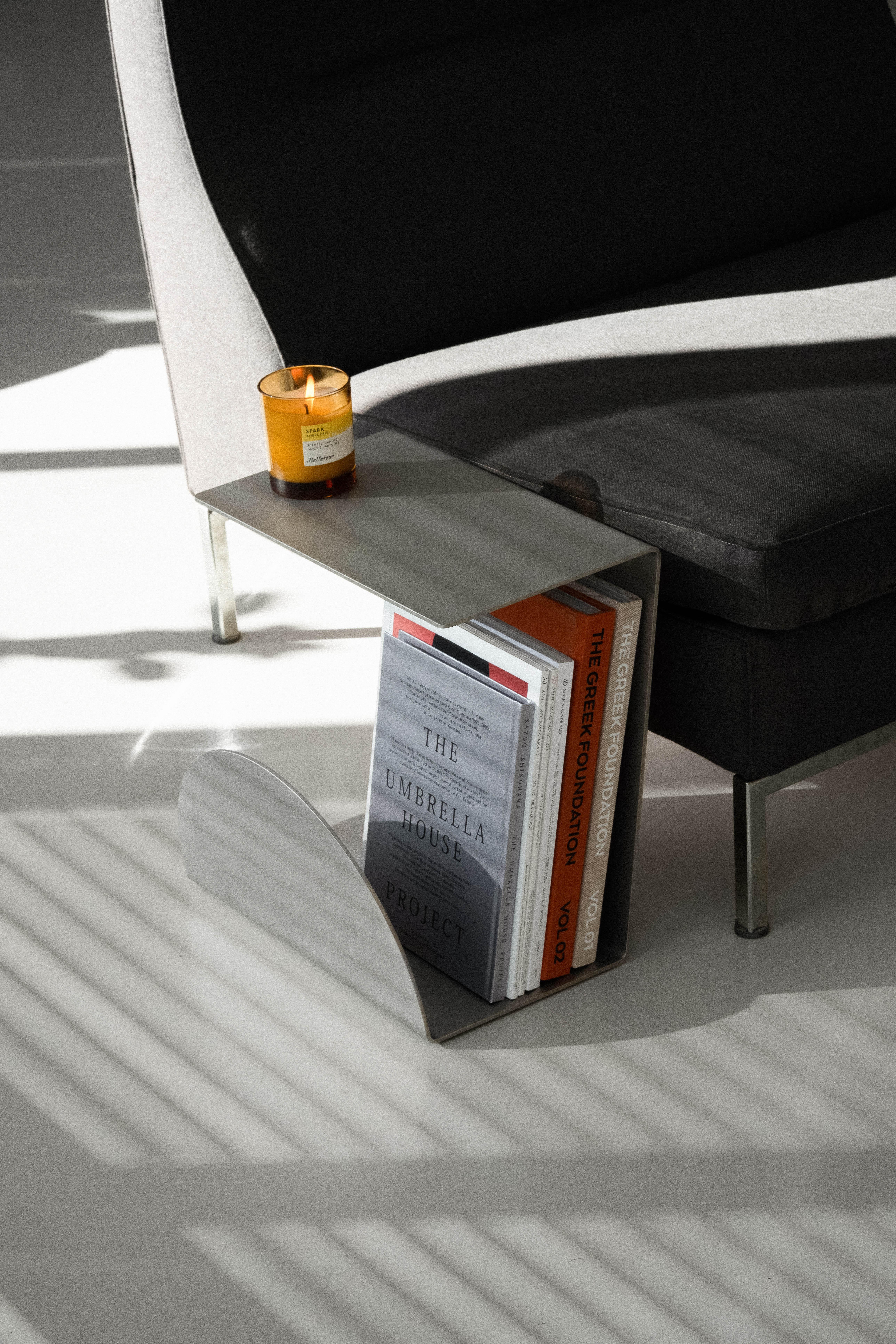 The Side Table from the X Collection combines modern elegance with functionality. Its elegant design in stainless steel, with a finely crafted top, seems to float above a curved base that offers the perfect space for storing your most beautiful