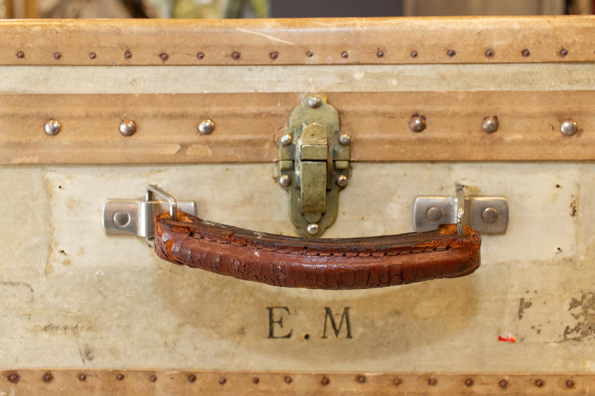 We sourced this very charming antique French luggage piece, well-traveled as evidenced by the attached assortment of labels, and imagined it as a side table. The custom, handcrafted base is attached to the bottom of the case, allowing the interior