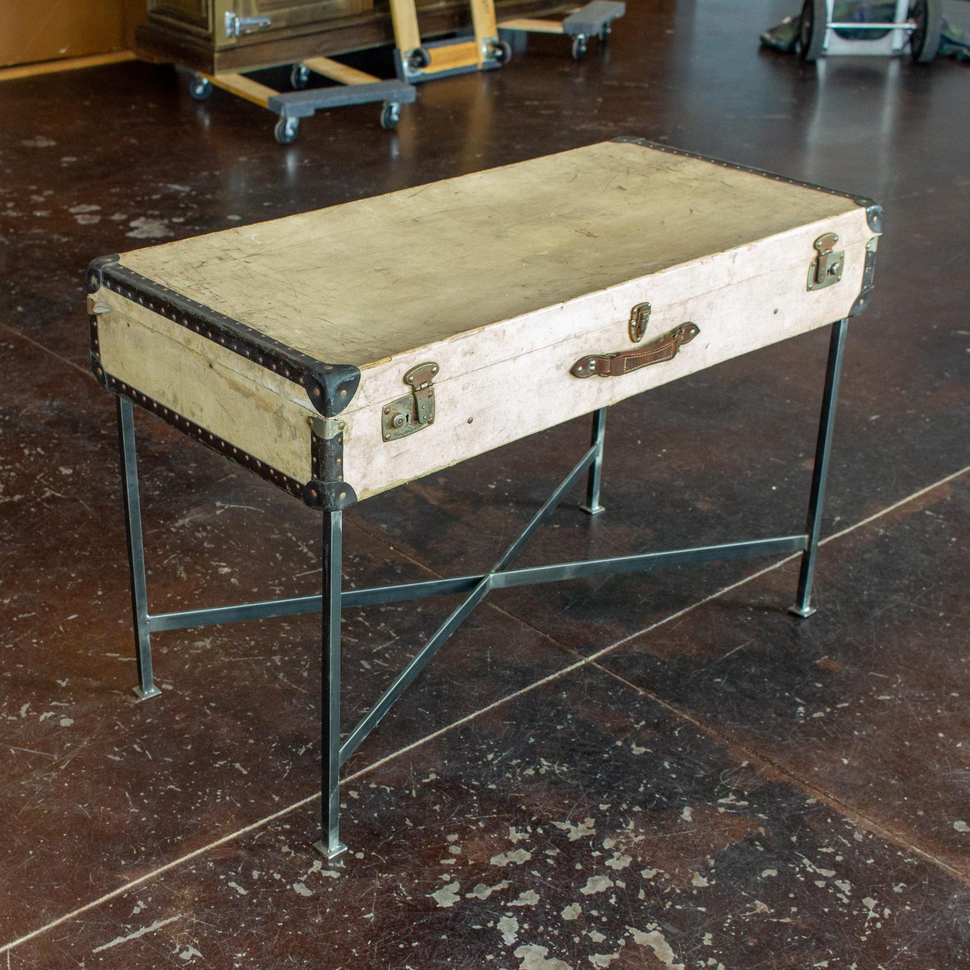 We sourced this very charming antique French luggage piece, well-traveled as evidenced by the wear, and imagined it as a side table. The custom, handcrafted base is attached to the bottom of the case, allowing the interior to be used for storage.