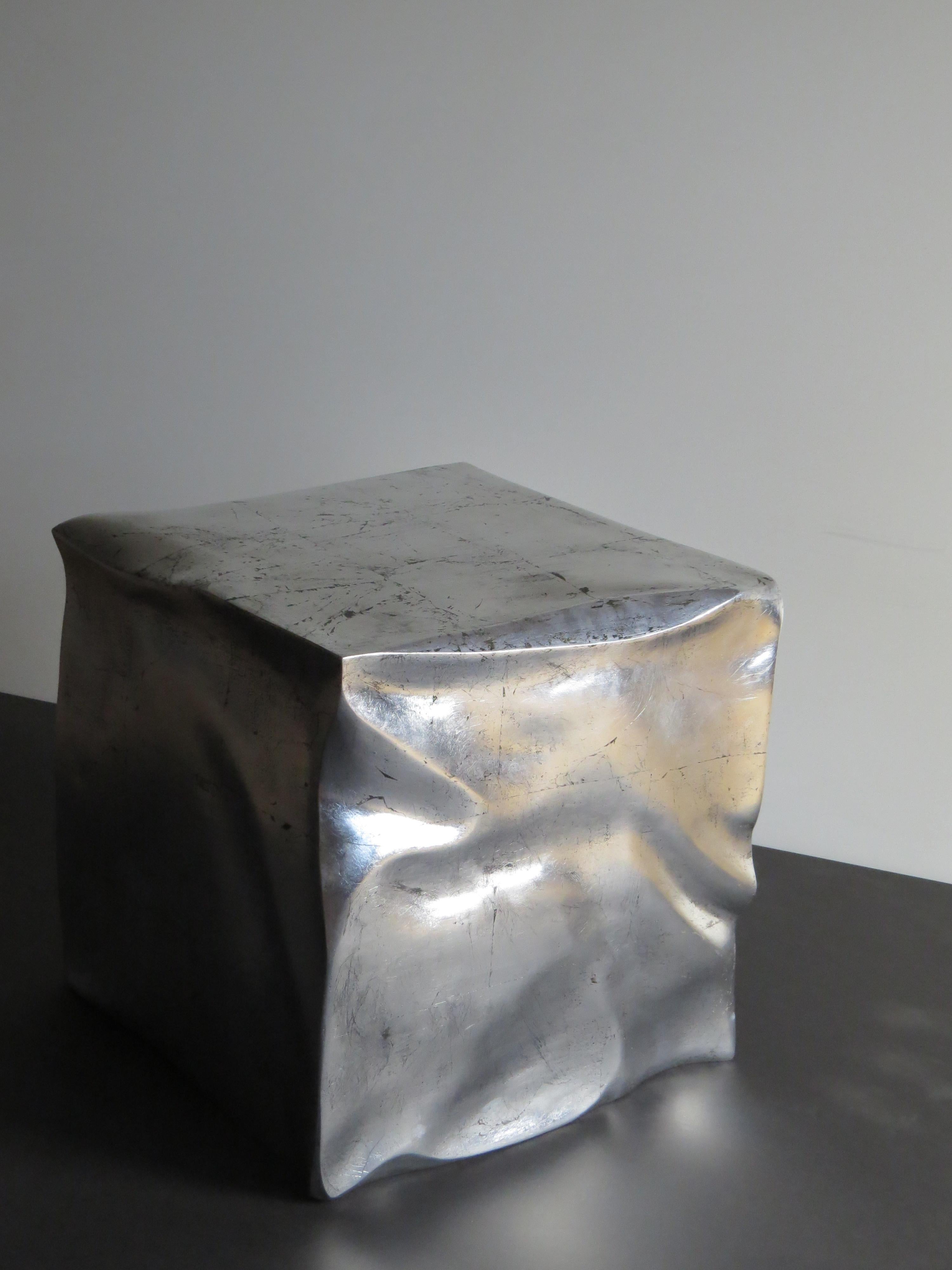 Handmade in organic design.
The cube is made of plywood, which is sculpted. The wrinkles and kinks are worked out - each cube is unique, the deformations are always different.
The surface is then silver plated and aged with impact metal.
An