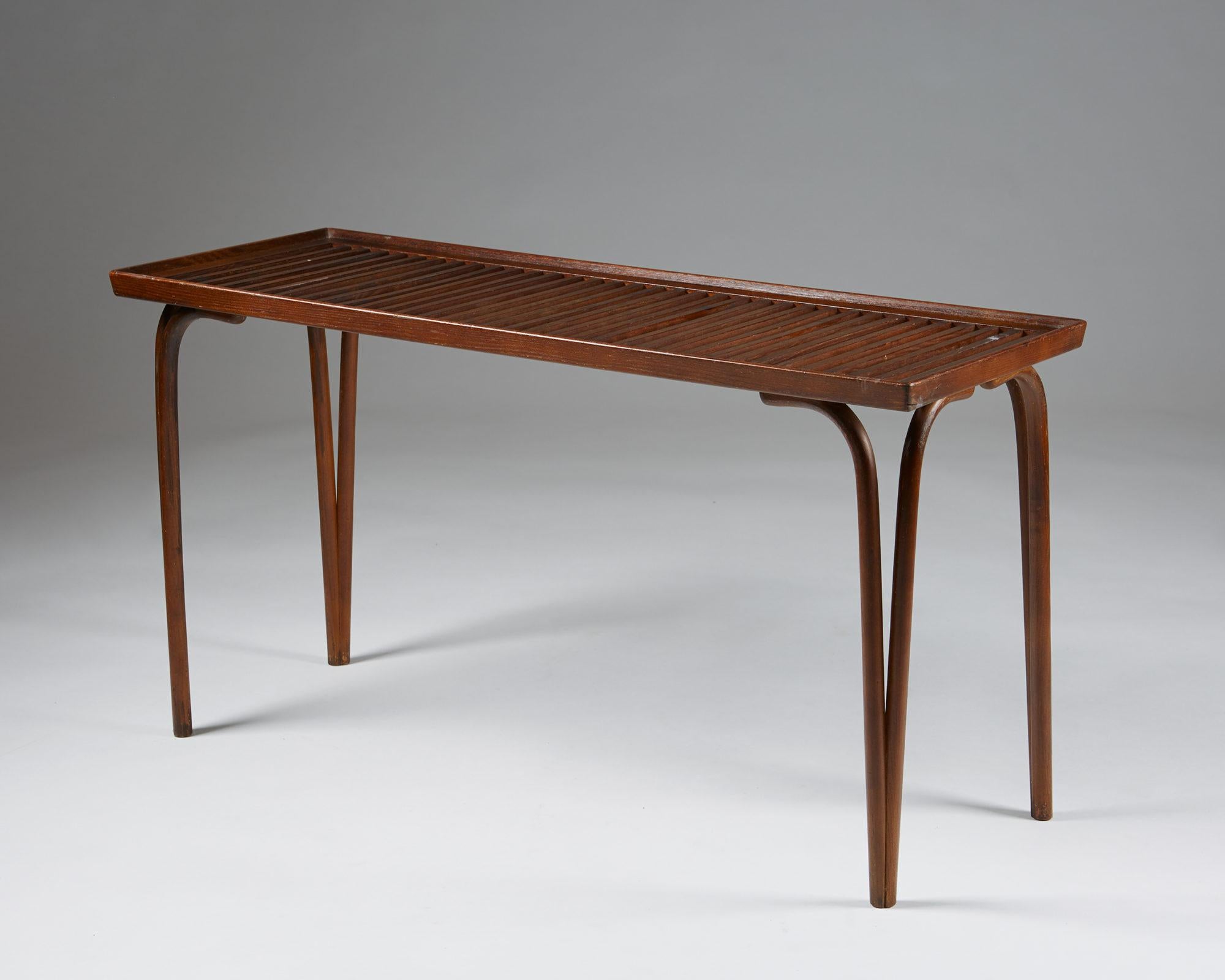 Side table designed by Carl Axel Acking for Svenska Möbelfabrikerna Bodafors,
Sweden. 1940's.

Stained oak.

Measurements: 
H: 56 cm/ 22''
L: 106 cm/ 3' 6''
D: 40 cm/ 15 3/4''