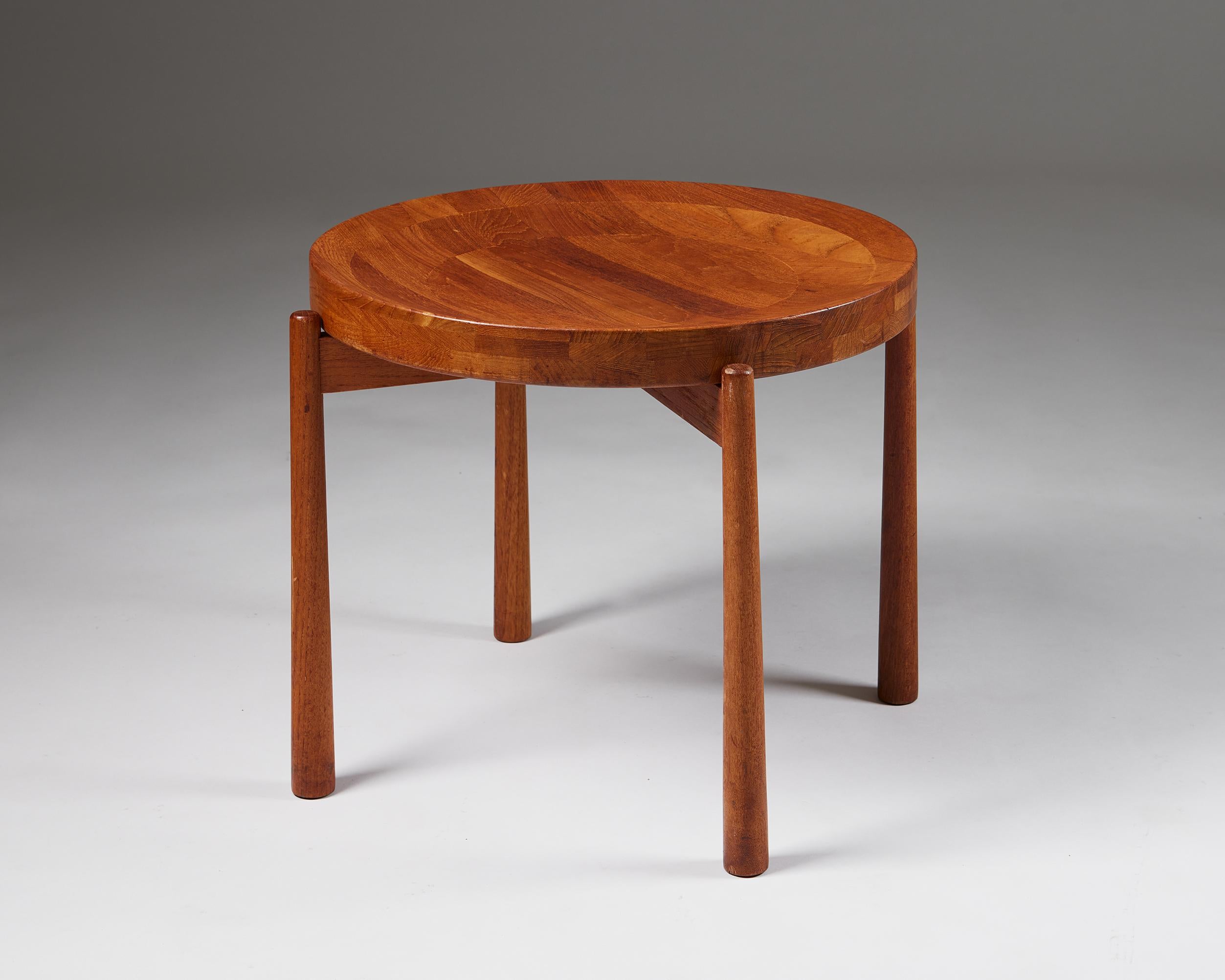 Side table designed by Jens Harald Quistgaard,
Denmark. 1950s.

Teak.

Exquisite woodwork and a beautifully shaped, removable tray surface that can function as a bowl characterise this Danish collectable. 

The sculptor Jens Harald Quistgaard worked