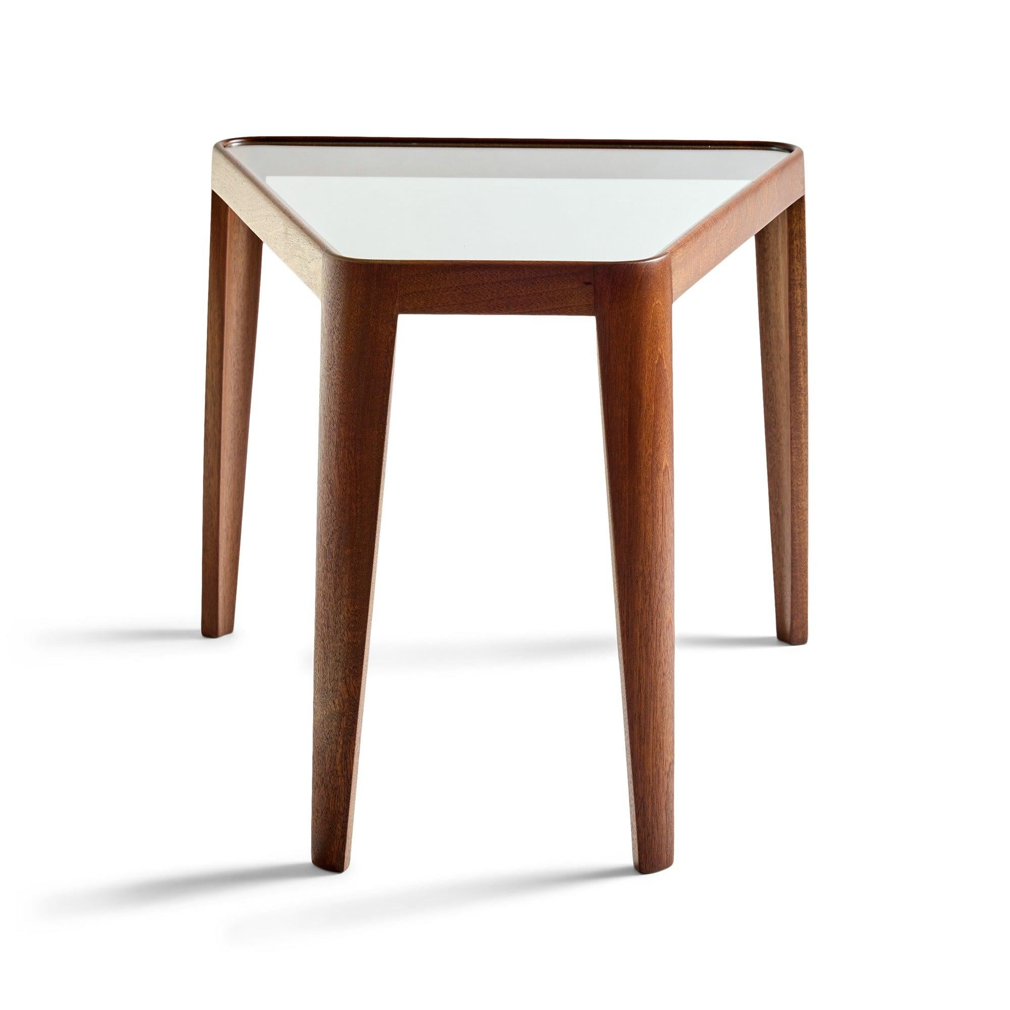 A trapzoid glass top side table in the original finish.