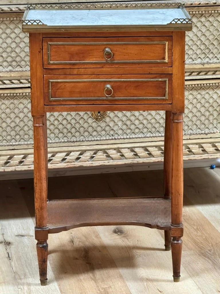 A French Directoire Marble-Top Walnut Side Table Circa 1800, Height 28 1/4 x width 16 1/2 x depth 12 inches.

