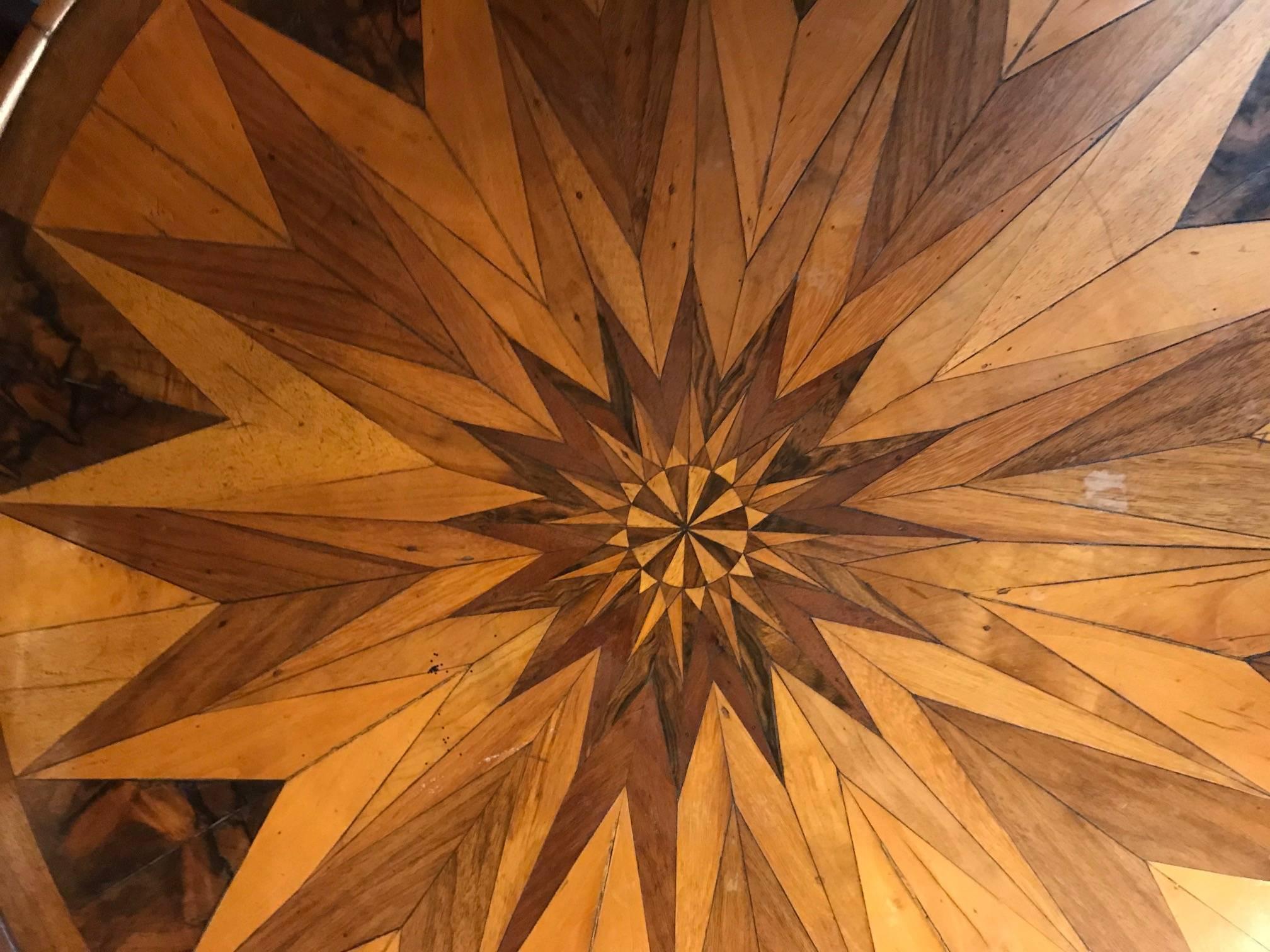 Side or center table, Germany, circa 1850. The table has a beautiful top, decorated with an exquisite star marquetry. Walnut and sycamore veneer. It is in very good condition. 