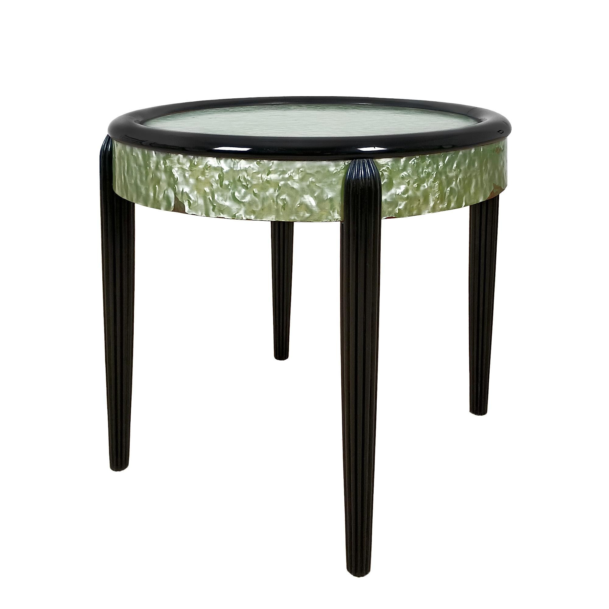 Side table with stained and varnished beech structure, surround and top upholstered in original green celluloid (small losses).

France c. 1925.