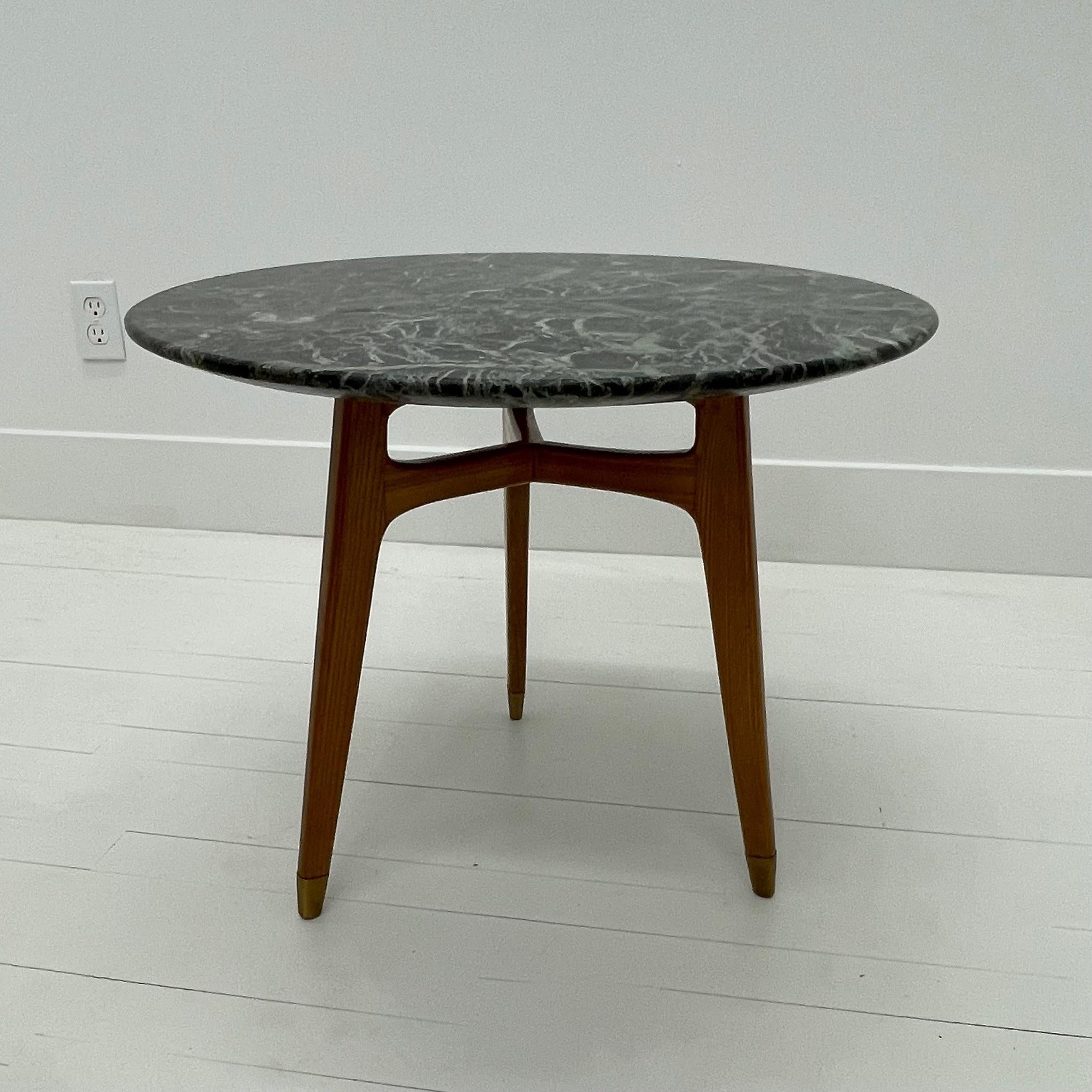 Side table in green marble, wood and brass, Italy, 1950's.

This simple, clean-lined side table has major presence as a result of its perfect proportions, burnished materiality and lovely craftsmanship. The legs terminate and slip into brass sabots