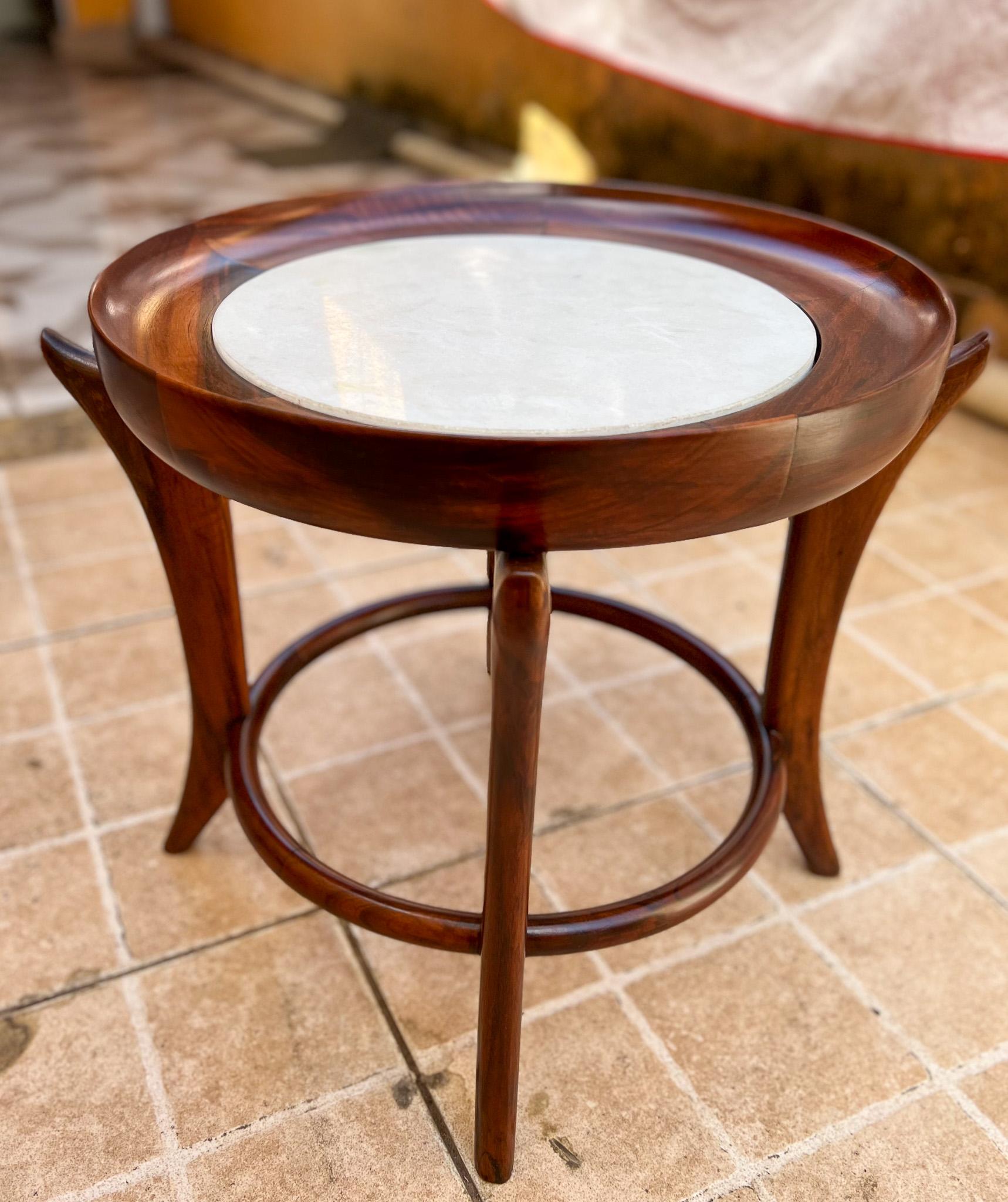 Available today, Giuseppe Scapinelli’s iconic Maracanã coffee table is made of Brazilian Rosewood, as known as Jacaranda and marble. The top has a circular wood base that holds the marble, giving a futuristic look when seen from above. The four