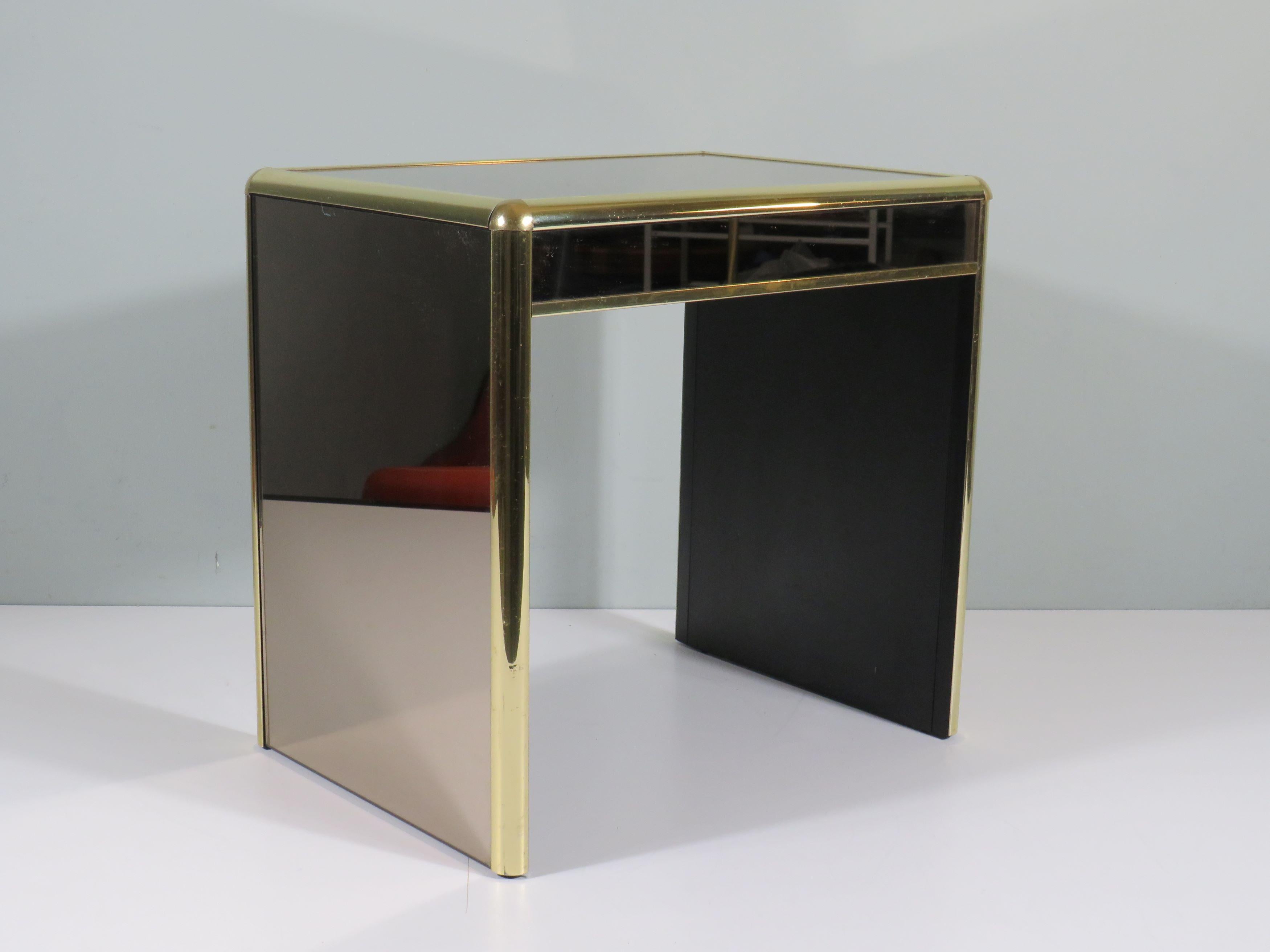 Heavy table with brass and smoked mirror glass.
In the style of Willy Rizzo and Tommassi Barbi.
If there is no shipping price listed for your place of residence, please do not hesitate to send me a message, I will be happy to provide you with a good