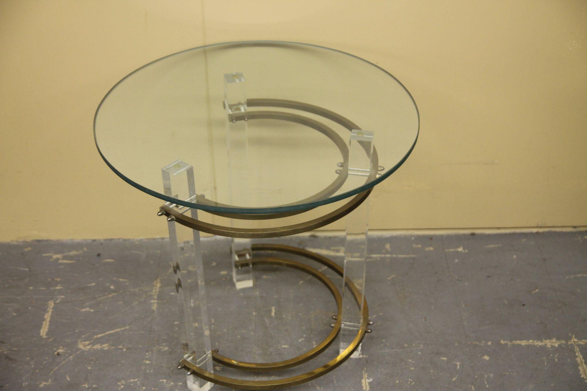 This nice vintage side table by Charles Hollis Jones is constructed with lucite legs, brass stretchers and glass top. In nice vintage condition. Will be posting the matching coffee table with oval top.