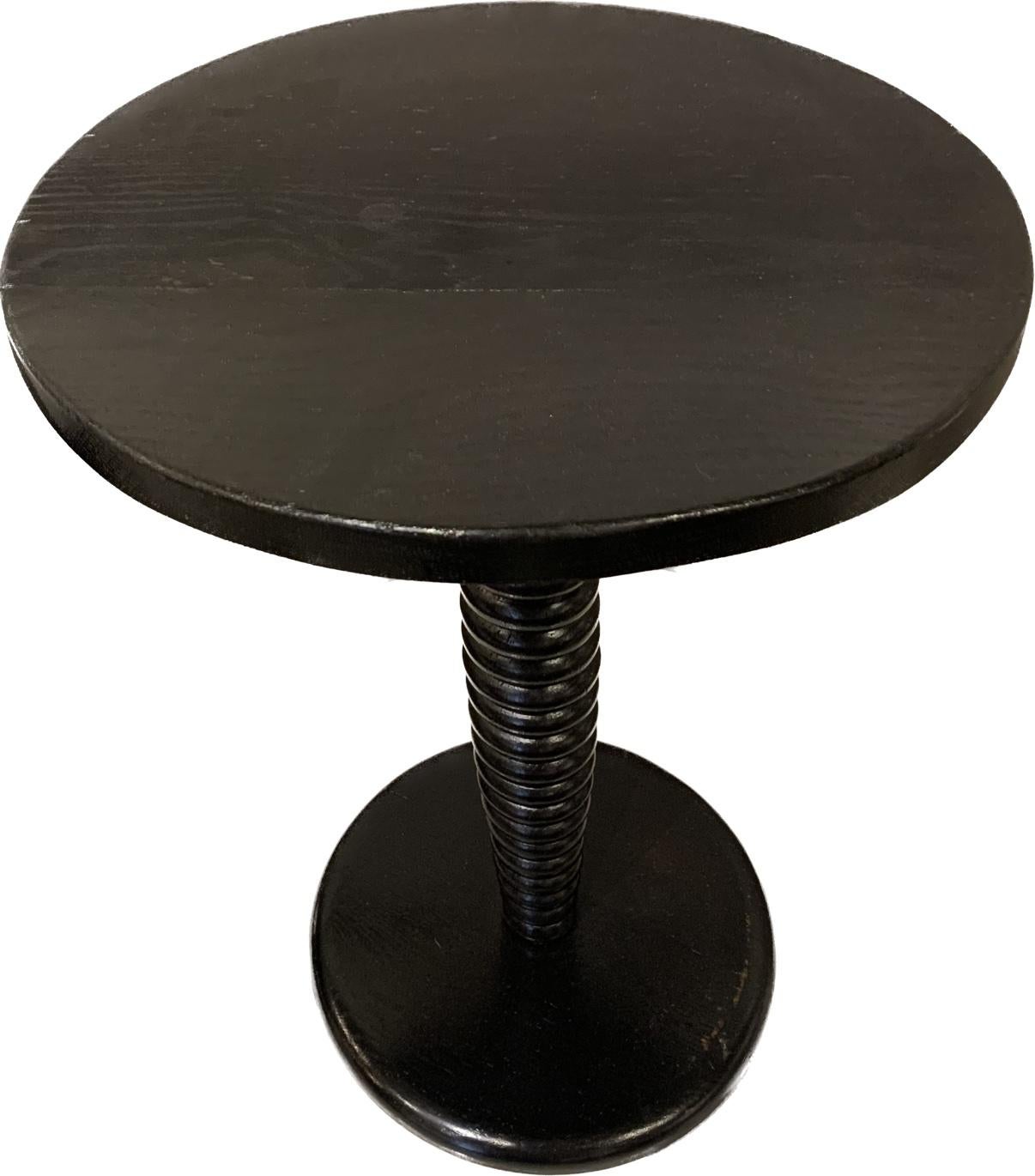 1940s French ebonized walnut side table in the style of Charles Dudouyt.
Round top.
Classic raised circular stack design pedestal.