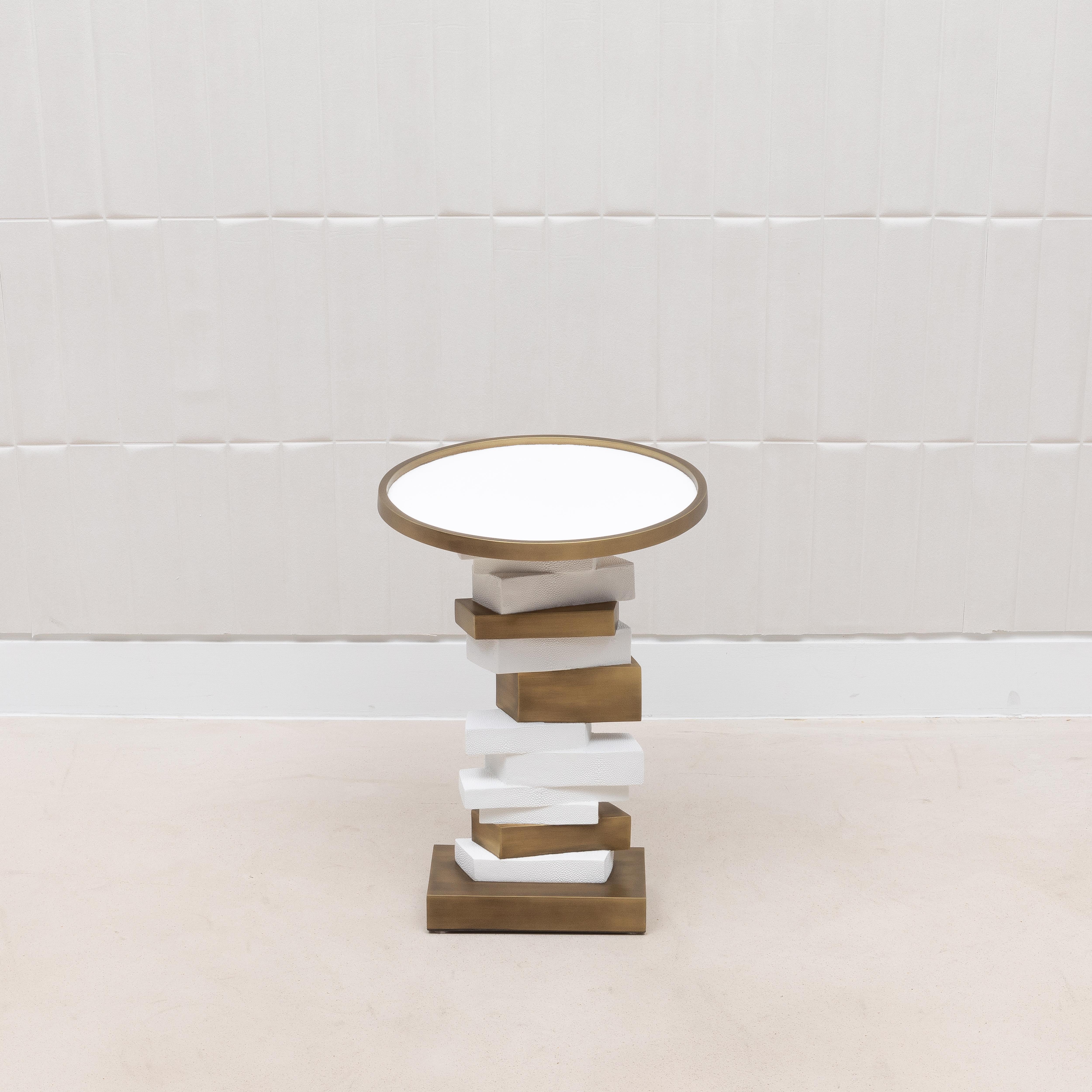 La table d'appoint Bullion de R&Y Augousti est une incarnation captivante du luxe moderne, où le design innovant rencontre l'artisanat exquis. Le plateau, encadré de laiton patiné bronze, offre une surface lisse et réfléchissante, tandis que la base