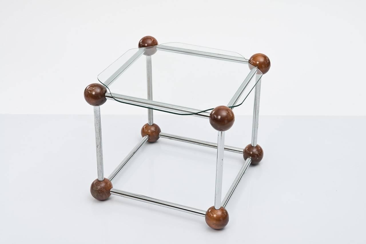 Style tables with a steel frame, joined by solid wooden balls on each corner, circa 1950. Original glass tops are cut to show off the wooden shapes.